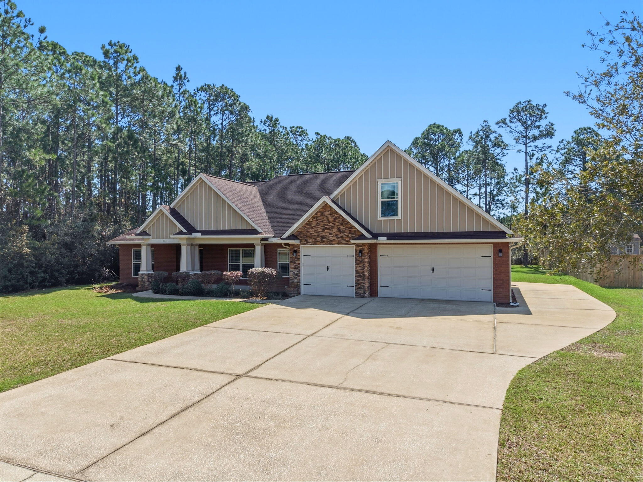 Welcome to this expansive and thoughtfully designed 5 bedroom, 3 bathroom, brick home with a 3 car garage - located in Navarre's Holley By The Sea neighborhood. Featuring a versatile, split floor plan with 1 of the 5 bedrooms on the second level with its own ensuite and oversized closet - perfect for guests or a secluded home office. The open concept main living space is the center hub of the home, boasting an elegant double tray ceiling for a classic, special touch. The kitchen has a dining room just off to the side, granite countertops, stainless steel appliances, and flows into the living space looking over the breakfast bar. The primary suite features a matching double tray ceiling and a spa-like ensuite with a large soaking tub, walk-in tiled shower, double vanity, and an oversized closet. Outside, you have an extended driveway for ample parking, a covered patio, and a large backyard - perfect for BBQs and outdoor entertaining. Enjoy all the amenities that Holley By The Sea has to offer - including a boat ramp, 8 clay tennis courts, a community event hall, 3 different pools, exercise room, and more!
