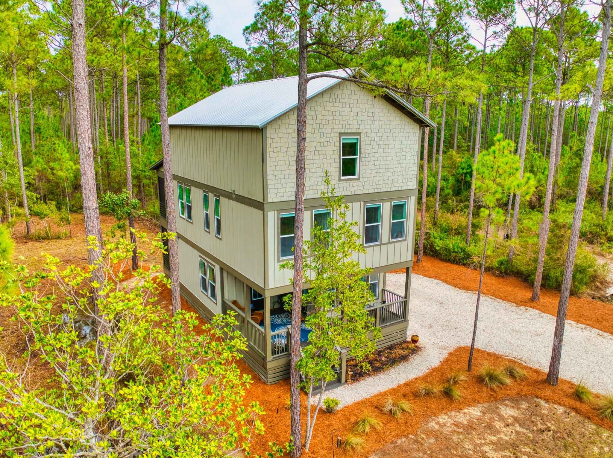 Welcome to 7537 Shady Glen Trail, located on the west end of Rivercamps on Crooked Creek: Panama City Beach's hidden wooden oasis. The development sits on 1,500 acres, two thirds of that being devoted to conservation. The community has a NEW zero-entry pool, approximately seven miles ofinterconnecting trails and boardwalks, boat launch and trailer storage, playground, pickle ball courts, designated campground space, NEW west-endmailboxes, and the community has officially broken ground for the future fitness center as of Nov. 2025! Rivercamps is nestled on the north side of West Bay conveniently located: 10 miles from the beach; less than 15 minutes to NW Florida Beaches International Airport (ECP); FSU/TMH Medical Campus; Watersound West Bay Center along 79 (Publix projected to open in 20 26); ~45 minute boat ride to Shell Island; future Point South Marina West Bay. Sitting on 0.62 acres, this 4 bed / 4 bath, 2492 SF home is ideal for a primary residence or second home with plenty of space to entertain. Situated on the first floor is the main living space with a half bath and kitchen, equipped with LG electric range and KitchenAid refrigerator and dishwasher. Step through the sliding glass doors onto the screened in porch with an additional fridge, perfect for entertaining morning coffee or dinner parties. The second floor hosts the primary bedroom with direct access to a screened-in balcony, spacious bathroom with plenty of storage, and walk-in closet. There are two other bedrooms on this level with opportunities to turn them into a home gym or office space nestled between the laundry area (LG WashTower Stacked Laundry Center). The third level has a second living area, full bathroom, and bedroom; within the bedroom is a hidden storage area with a door disguised as a bookcase for easy access to additional storage.
