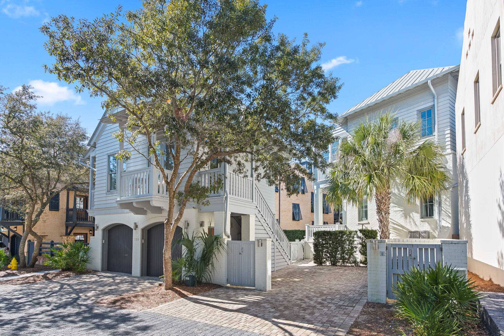 This impeccably maintained 5-bedroom, 7-bathroom home offers approximately 3733 square feet of thoughtfully designed interior living space, complemented by over 650 square feet of covered outdoor balconies and porches. The property includes a charming detached carriage house, ideal for guests or potential rental income.

The first floor showcases an expansive open floor plan that effortlessly blends sophistication with functionality. Dual living areas flow into a formal dining space, all anchored by a gourmet chef's kitchen featuring a professional Dacor range, Sub-Zero refrigerator, wine cooler, separate ice maker, and granite countertops. The butler's pantry with additional full-size refrigerator provides exceptional convenience for entertaining. Step outside to your private oasis where the inviting pool and spa create the ultimate backdrop for coastal living. The outdoor living space is complete with built-in natural gas grill, multiple seating and dining areas, and an outdoor shower for rinsing off after beach days.

The detached carriage house epitomizes low-country charm with its open living concept and half bath on the main level. Upstairs, discover a serene bedroom suite with full bathroom. This self-contained retreat includes a full gourmet kitchen with stainless appliances, in-unit washer/dryer, and dedicated garage. Wrap-around balconies extend the living space and capture gentle coastal breezes.

Experience the coveted Rosemary Beach lifestyle in this exceptional property where every detail has been considered.
