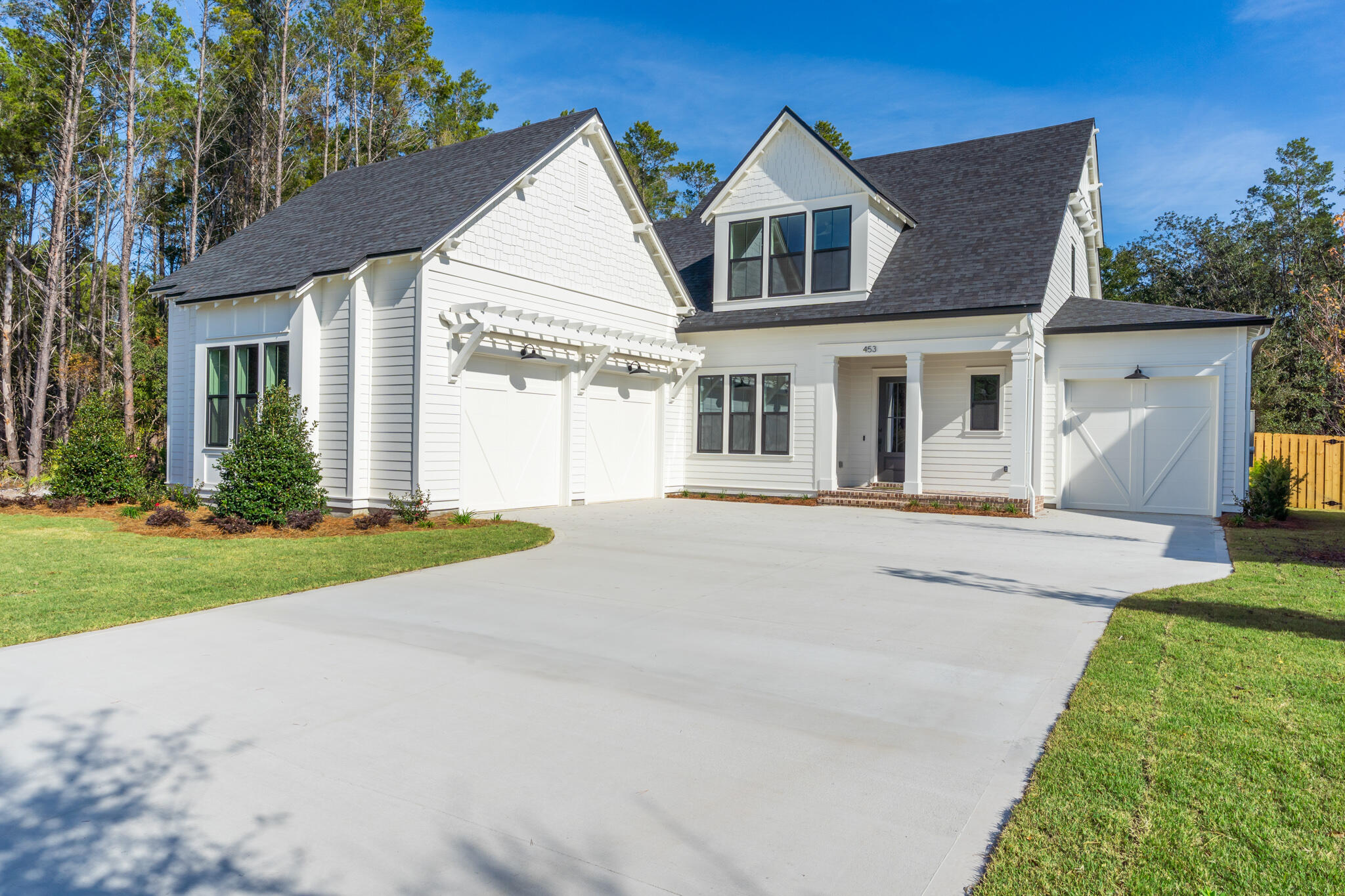This elegant coastal design with lake views offers an open-concept layout featuring a family room with fireplace, a chef's kitchen with large island, walk-in pantry, dining area, and seamless access to the covered rear patio. The private owner's suite retreat includes a soaking tub, walk-in shower, dual vanities, and expansive closet space. Other highlights include a mudroom/drop zone, laundry room, and a 3-car garage. Residents of Reflection at Hammock Bay enjoy resort-style amenities, scenic trails, and community green spaces as well as the nearby Bay Club.  Other features include wood floors throughout, cabinets to ceiling in kitchen, 10' ceilings, solid core interior doors, incredible landscape front and rear.  Florida Coastal Architecture Meets Hammock Bay!!!
