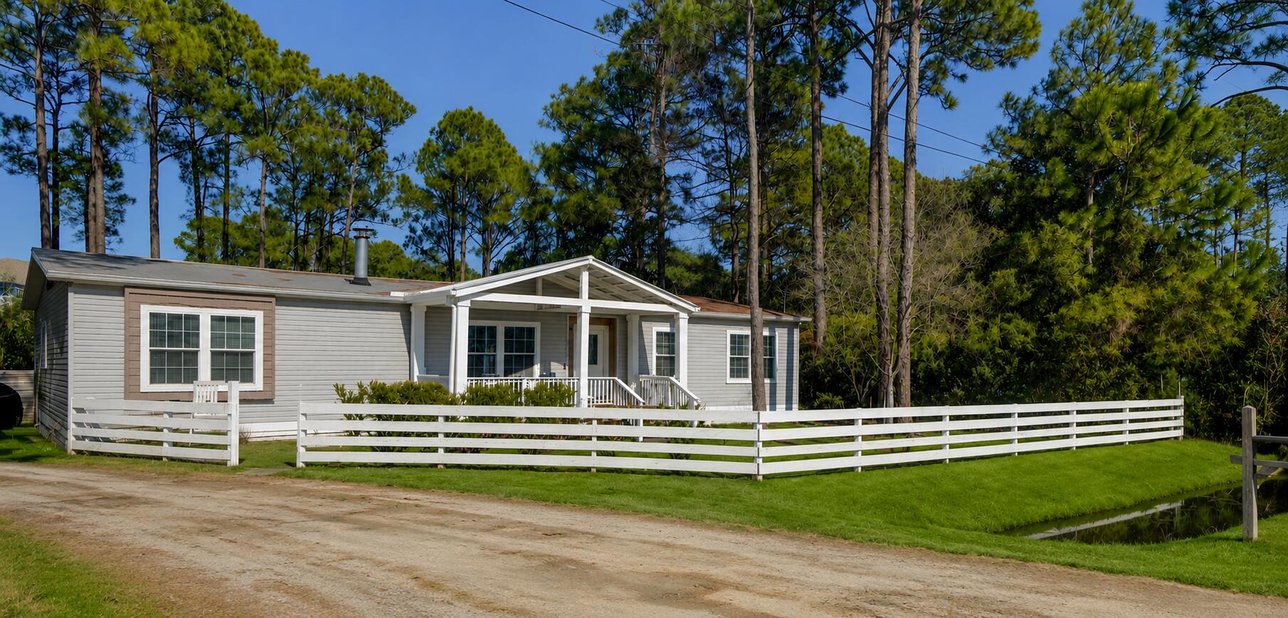 Beautifully Updated 3 Bedroom, 2 Bath Manufactured Home
Step inside this spacious and inviting home featuring vaulted ceilings and bamboo wood flooring that create an airy, modern feel throughout. The open‑concept kitchen is a true highlight, complete with an island, white cabinetry, gas stove, walk‑in pantry, recessed lighting, and stylish modern fixtures.
The split bedroom layout includes a generous primary suite with an oversized soaking tub and a large shower, offering a spa‑like retreat. Each bedroom is equipped with a ceiling fan, ensuring year‑round comfort. A versatile bonus area provides the perfect spot for a home office, hobby room, or additional living space. Enjoy peaceful outdoor living with a screened in back porch featuring warm wood beams, ceiling fans, and a cozy fireplace, ideal for relaxing or entertaining. The nicely wooded backyard offers privacy and a natural backdrop, while the detached shed adds convenient storage.
This home blends comfort, charm, and practicality ready for you to move in and enjoy!