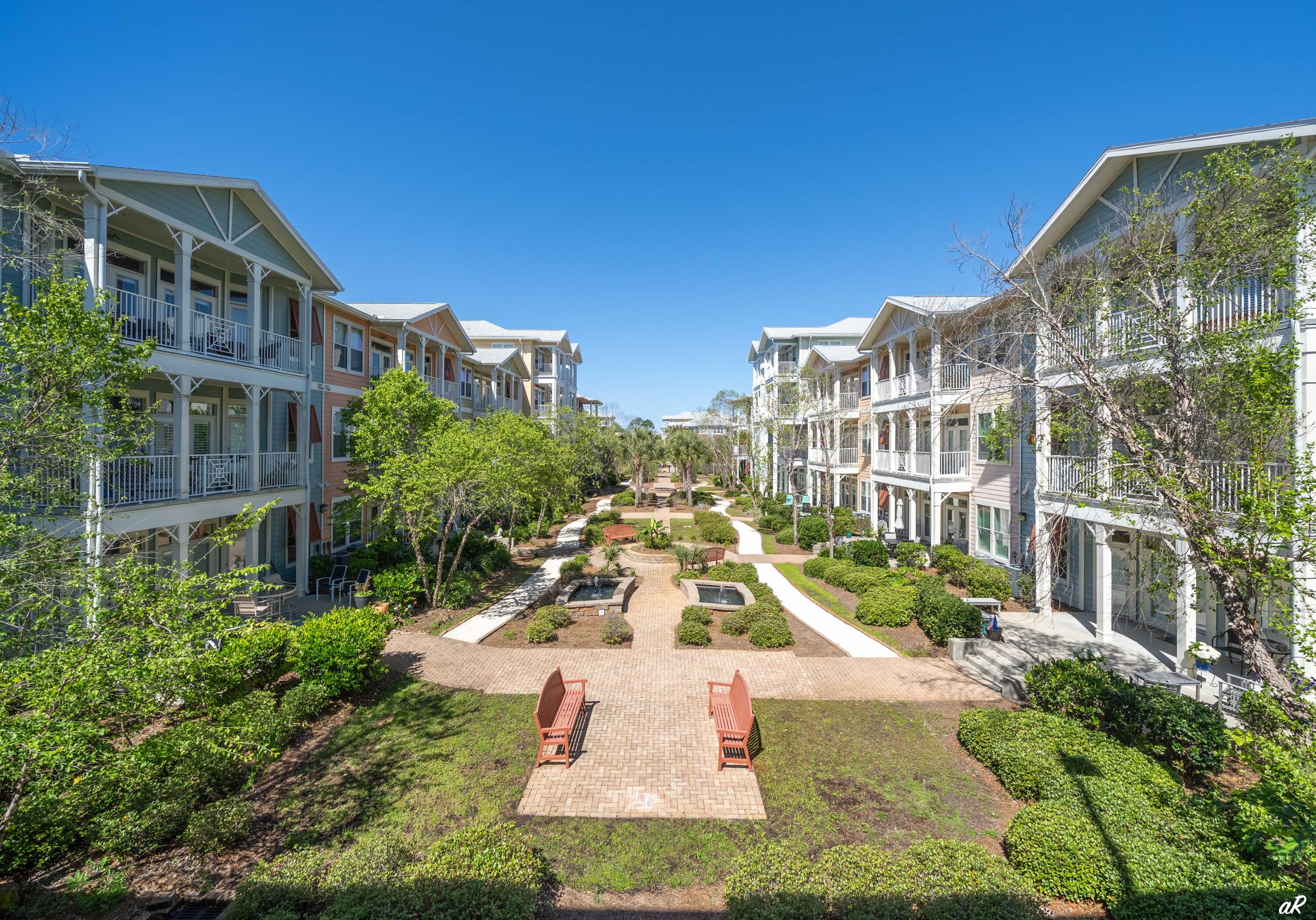 Experience elevated coastal living in the heart of Panama City Beach, renowned for its miles of sugar-white sand and the emerald-clear waters of the Gulf of Mexico. Nestled within a fully gated, resort-style community surrounded by lush tropical foliage and scenic walking paths, this exceptional residence offers the perfect blend of luxury and leisure. Residents enjoy world-class amenities, including a spectacular one-acre lagoon-style pool, game and theater rooms, basketball and pickleball courts, and a state-of-the-art fitness center -- all designed to make every day feel like a vacation. This condo features 1 bedroom, 1.5 baths, and a versatile bonus room, thoughtfully designed across two spacious levels.  The main floor welcomes you with a generous living and dining area, a spacious kitchen, convenient half bath, and two oversized storage closets perfect for beach and pool essentials. Upstairs, the owner's suite serves as a private retreat, complete with a cozy sitting area, spa-inspired ensuite bath, two large walk-in closets, dedicated laundry area with additional cabinetry, and a flexible bonus room ideal for guests or a private office. Two private balconies provide the perfect setting to enjoy morning coffee or evening sunsets, while soaring 10-foot ceilings, elegant crown molding, and dramatic floor-to-ceiling windows flood the home with natural light and elevate the space to impressive new heights. Whether you're seeking a full-time residence, a second home, or long term rental investment opportunity, this stunning condo delivers refined comfort in one of Florida's most desirable beach destinations. Please note that the photos match the floor plan but are not photos of the actual unit due to renter in place. Floor plan is in the documents tab.