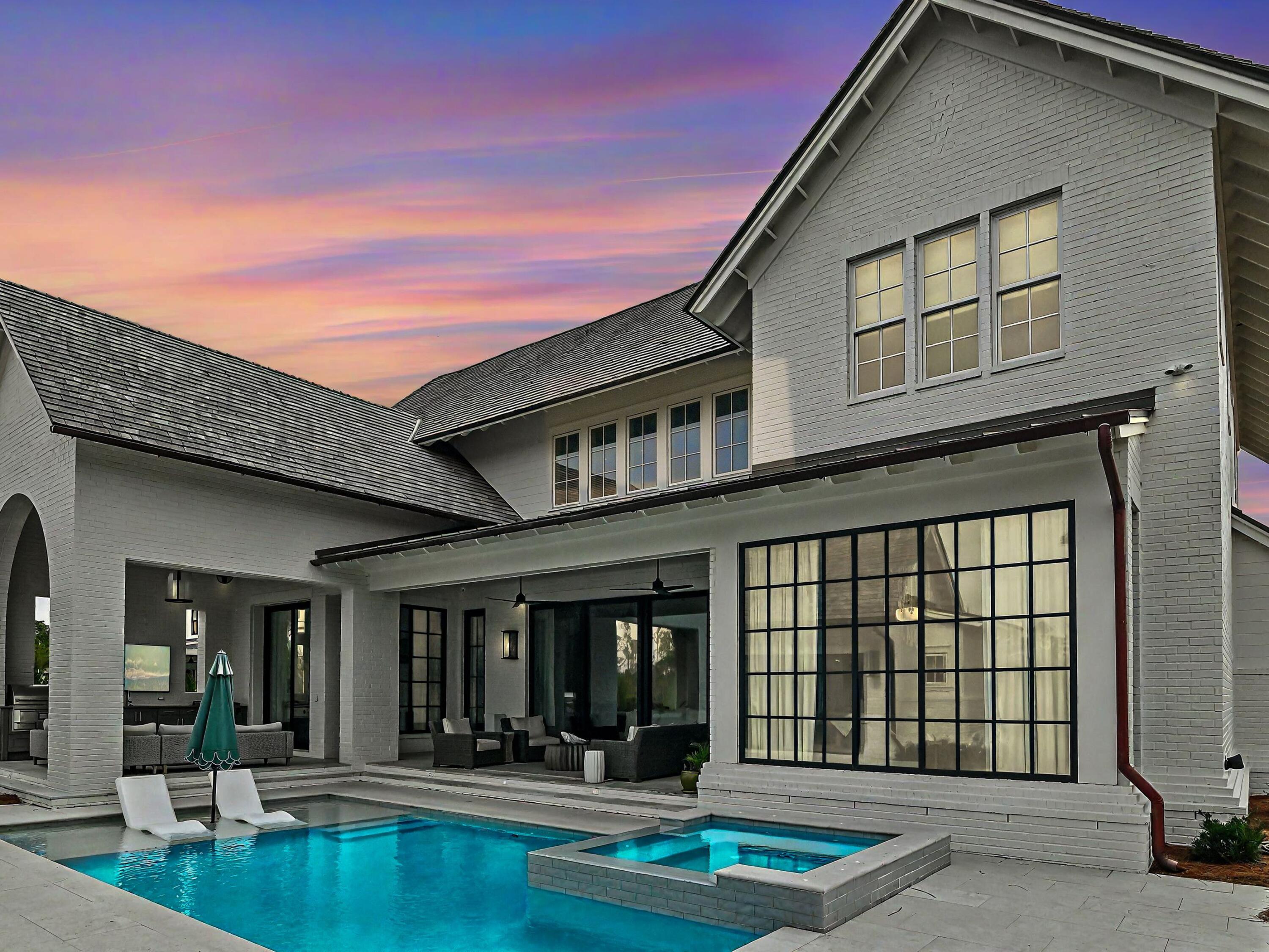 Thoughtfully designed by Greg Jazayeri, expertly built by Regal Stephens, and exquisitely finished and furnished by Tracery Interiors, this four-bedroom, five-and-a-half-bath custom home in Watersound Camp Creek embodies craftsmanship at its highest level. From the moment you enter, every detail reflects artistry and intention -- from the coral stone floors that flow seamlessly indoors and out to the natural marble and quartzite countertops and handcrafted Grimes cabinetry.

The primary suite is located on the main level, creating an easy rhythm between private retreat and open gathering space. Expansive sliders blur the line between the living room and the outdoor entertaining area, where dual grills, a spa, and a cabana with pool table set the tone for relaxed sophistication.
