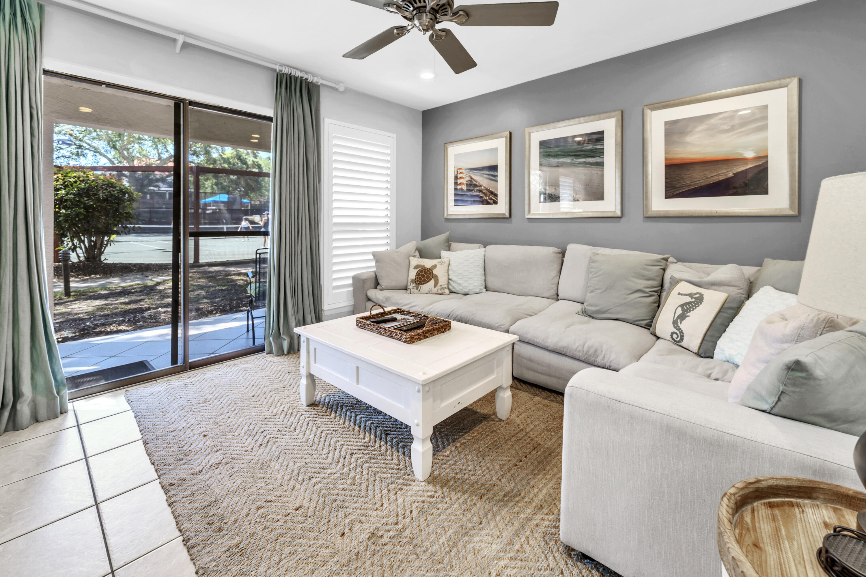 NICELY UPDATED with Tennis views!  Welcome to Tennis Village located in the private, gated community of Tops'l Beach Resort. This unit is being sold fully furnished and turnkey ready.

The unit boasts two covered porches and a private, open air deck. As you head inside the property through the covered carport, you are greeted by the open living space of the kitchen, dining room, and living room. The kitchen has all stainless steel appliances and quartz countertops. There is no carpet to be found anywhere in the unit, providing for easy maintenance.

Off the living room is the first covered porch with direct views of 2 of the 12 Rubico clay tennis courts. The setting must be seen to be believed! You will also find a half bath and owners closet on the first floor.

Headed up to the second floor soon you will discover that luxury vinyl plank flooring has been installed and both bedrooms have been recently painted. Both bedrooms upstairs have their own private bathrooms. The guest room located on the front of the unit has access to the private, open air deck, perfect for sunbathing, or just enjoying a little bit of privacy outside. The attached private bathroom has a shower/tub combo.
The primary suite located toward the back of the unit has access to the second covered porch overlooking the tennis courts. The master bathroom features a double vanity, and floor to ceiling tiled shower with sitting bench. Being in the community of Tops'l Beach Resort, you have access to 600 feet of private beach, onsite rental management, world class tennis and fitness center with an indoor/outdoor pool, tram service to the beach, and onsite restaurant. Tops'l is located on the outskirts of Miramar Beach, only a short distance from dining and shopping at Silver Sands Outlet Mall, Grand Boulevard, Baytowne Wharf, and so much more.