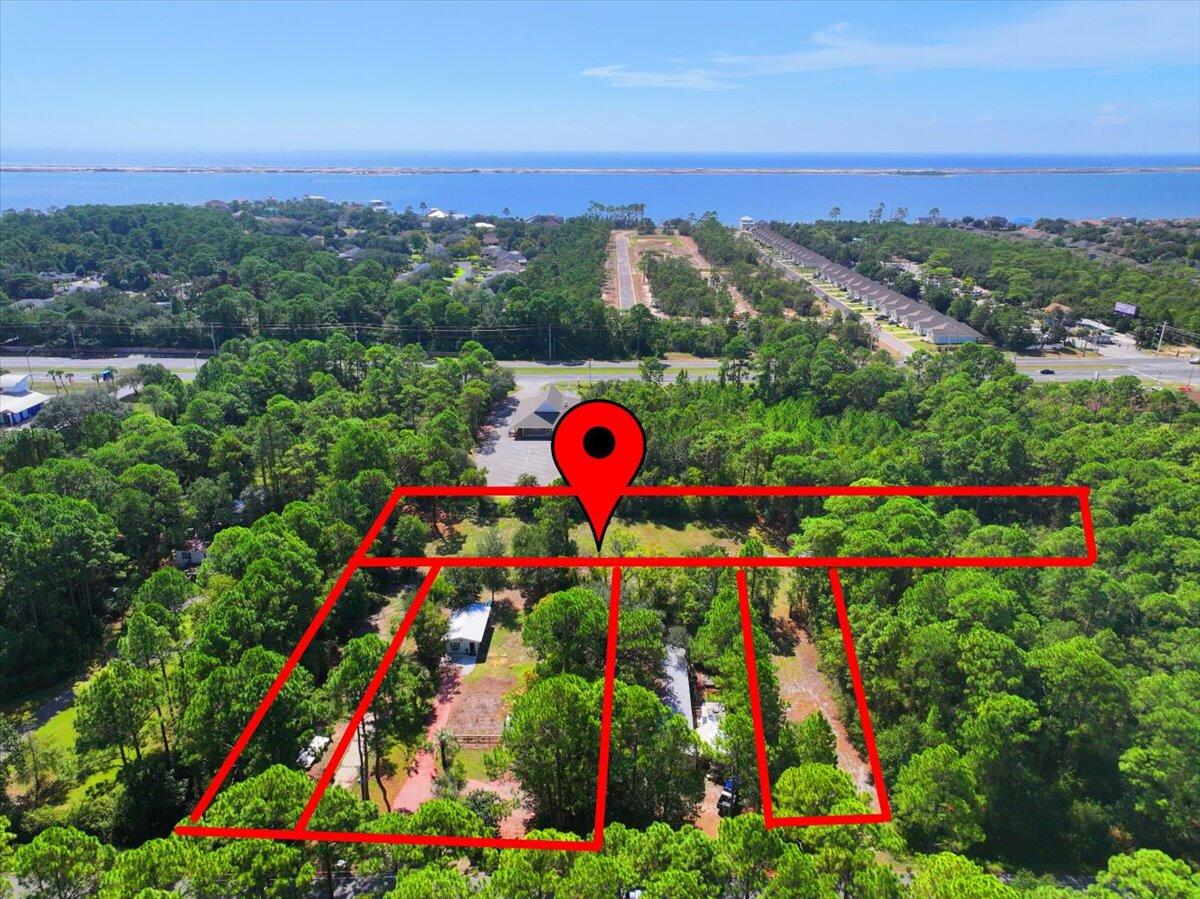 *Back Up Offers & Showings still accepted* Oh, the potential with this unique bundle of three adjacent parcels in Navarre, Florida! This rare land + home package offers a valuable mix of residential zoning and commercial zoning, making it ideal for investors, developers, business owners, and buyers seeking live/work property in the fast-growing Florida Panhandle.
This multi-parcel property presents endless possibilities: build a custom home, develop multiple homes, create a mixed-use property, establish a small business location, or hold as a prime investment property in a high-demand coastal market near Navarre Beach, Pensacola, and Fort Walton Beach.
The existing residence features a newer roof (within the past 4 years) and offers excellent flexibility--live in the home while you build, use it as a home office, rental, , or business space, or remove it to maximize your development footprint. All three lots are cleared or partially cleared, saving time and money and providing a head start for new construction or redevelopment.
The improved parcel includes public water and sewer, a charming cottage, and a shed with a one-year-old roof. The larger commercially zoned parcel features a four-bay barn, ideal for storage, workshop use, small business operations, or future commercial redevelopment.
Whether you're searching for land for sale in Navarre, FL, commercial property, residential land, an investment opportunity, or development property near the Gulf Coast, this rare three-lot package delivers location, flexibility, and upside potential.