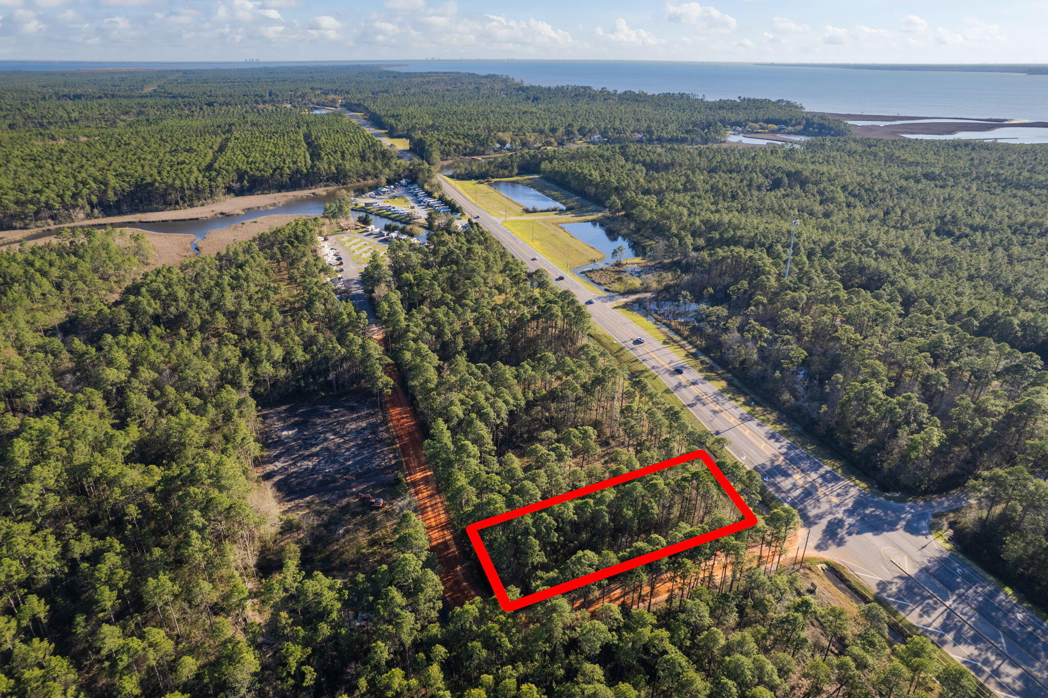 SELLING BOTH PARCELS TOGETHER: 40-1N-28-0090-22400-0010 & 40-1N-28-0090-22400-0240. This unique commercial property consists of two adjoining parcels, creating a larger combined lot with 100 feet of road frontage on a high-visibility corner on Avalon Blvd. With a dedicated turn lane already in place for easy access and close proximity to the I-10 exit, this location offers excellent potential for a variety of business opportunities. Utilities are available at these lots. Zoned commercial and situated in a rural area that is seeing continuous growth and development, this lot provides a great opportunity to establish a business in an emerging market. Don't miss the chance to invest in this expanding area!