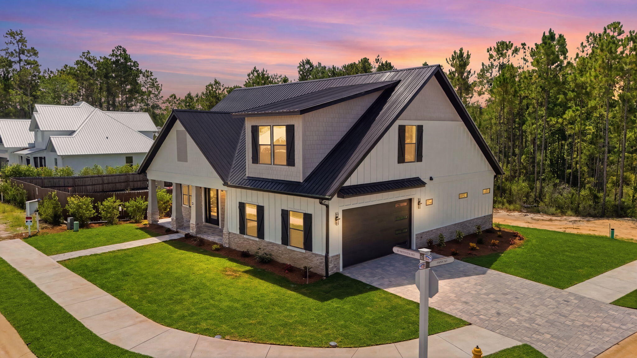 Welcome to modern coastal elegance in the Bear Creek community. This brand-new custom build seamlessly blends high-end architectural design with casual, everyday comfort. From the moment you walk through the door, you're greeted by bright, sun-filled living spaces, light oak-style flooring, and luxury finishes. 

The chef's kitchen is designed to be the heart of the home, featuring custom white and wood-tone cabinetry, brushed gold hardware, a pot filler, a geometric mosaic backsplash, and an expansive island anchored by designer pendant lights. 

The open main living area centers around a striking floor-to-ceiling fluted fireplace feature and opens through oversized sliding glass doors directly onto a quiet, private screened-in porch offering the perfect spot for morning coffee or evening wine with views of peaceful surrounding greenery.

Designed for maximum versatility, the home includes a dedicated main-level office space alongside a secondary upstairs flex loft with custom slat wall detailing--ideal for a play area or a media room. 

The spa-inspired primary suite serves as a luxury retreat, boasting a custom walk-in closet system and an ensuite bath complete with dual fluted vanities and a floor-to-ceiling marble glass shower with dual shower heads. 

Beyond the home's striking exterior curb appeal, accented with black metal roofing, board-and-batten siding, stone pillars, and a paver driveway. Bear Creek offers a vibrant resort lifestyle ... Enjoy premier neighborhood amenities including a resort-style pool, fitness center, tennis and pickleball courts, basketball court, playground, and scenic walking trails. Schedule your private tour today to experience this custom masterpiece