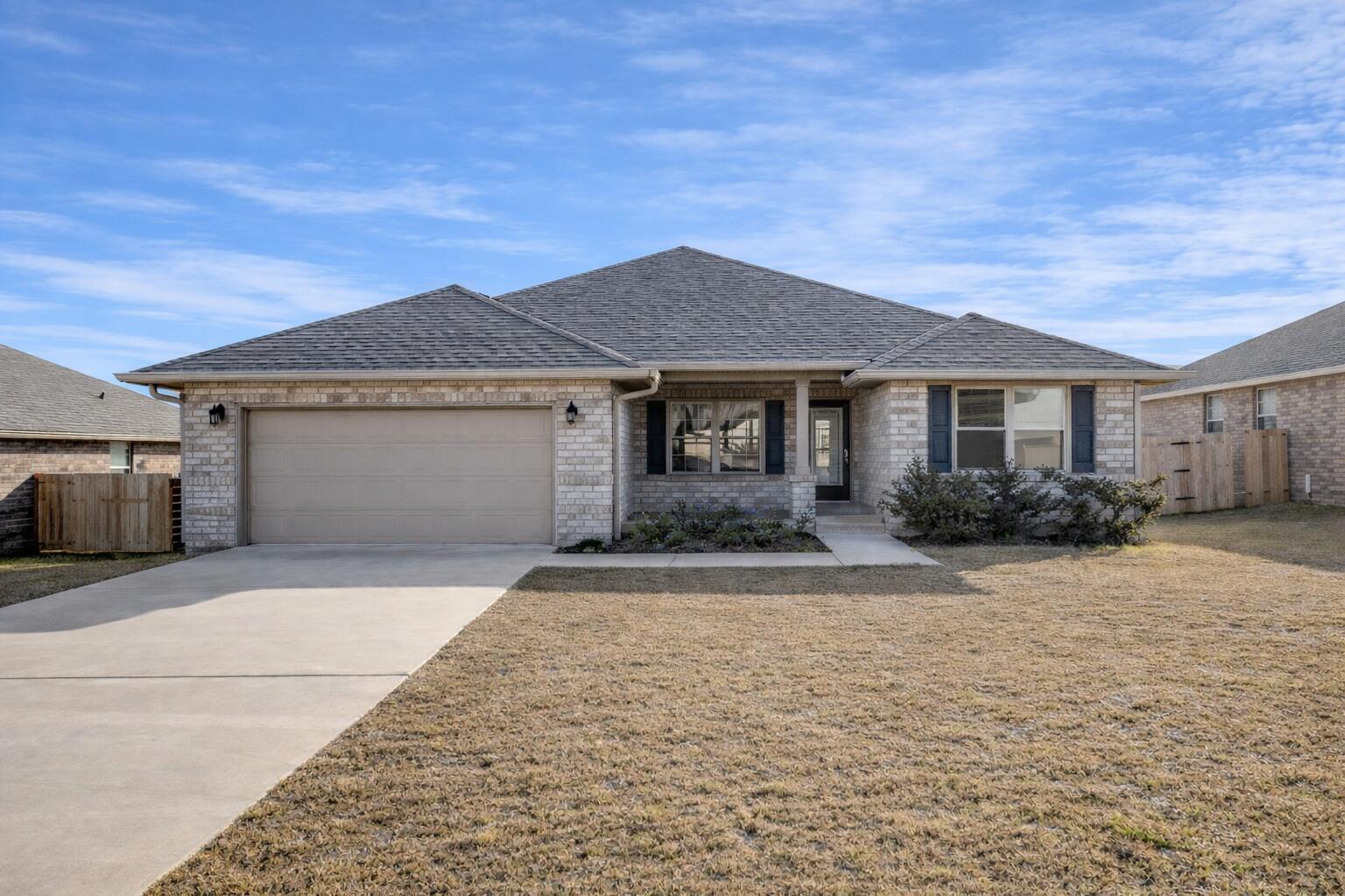 Welcome to this beautifully maintained, move-in ready residence offering 4 bedrooms, 3 full bathrooms, and a thoughtfully designed split-bedroom floor plan that blends comfort, privacy, and refined everyday living.

Step inside to a bright, open layout enhanced by modern finishes and a seamless flow throughout the main living areas. The spacious kitchen serves as the heart of the home, showcasing white lace quartz countertops, gray Cape Cod-style cabinetry, stainless steel appliances, and a large walk-in pantry that provides both function and convenience.

Luxury vinyl plank flooring extends through the main living spaces, creating a clean and cohesive feel, while the carpeted bedrooms offer warmth and comfort. The bathrooms continue the home's elevated design with matching cabinetry and quartz countertops, giving each space a polished, upscale finish.

The open-concept family room connects effortlessly to the kitchen and breakfast nook, creating an inviting space for entertaining, gathering, or enjoying quiet evenings at home. A separate formal dining room adds versatility and can easily serve as a home office, playroom, sitting area, or flex space to fit your lifestyle.

The spacious primary suite offers a peaceful retreat with abundant natural light and a well-appointed ensuite bathroom designed with both style and convenience in mind. The additional bedrooms are generously sized and thoughtfully positioned to provide privacy for family members or guests. Added upgrades include blinds, gutters, and a fully paid security system, offering extra comfort, peace of mind, and value. With its elegant finishes, functional layout, thoughtful upgrades, and move-in ready condition, this home is ready to welcome its next owner.