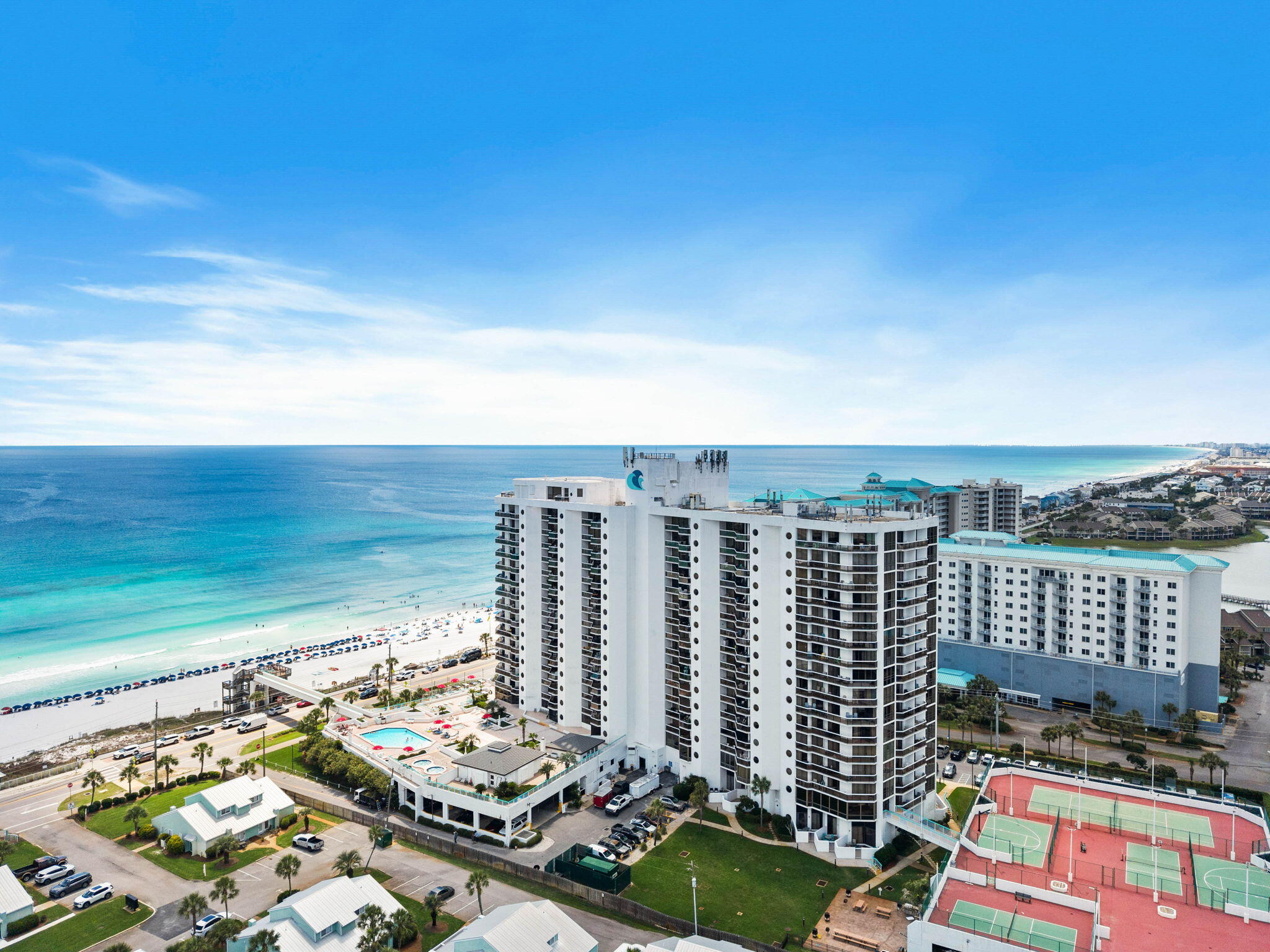 Perched above the emerald waters, this beautifully updated two-bedroom, two-bathroom condo at Surfside Resort offers the ultimate coastal escape, complete with stylish decor throughout and a full lockout owner's suite. The highlight of the home is the expansive balcony, which along with both bedrooms showcases breathtaking, panoramic views of the Gulf of Mexico. Steps from your door, the resort's premier amenities await, including 300 feet of private beach with dedicated beach service, an elevated beach walkover, a heated pool, multiple hot tubs, and the on-site Royal Palm Bar & Grill. Perfect for active lifestyles, the property also features a fitness center, tennis and pickleball courts, and a bike path right outside that offers a fantastic way to explore the area's vibrant restaurants and local attractions. Schedule a tour today!