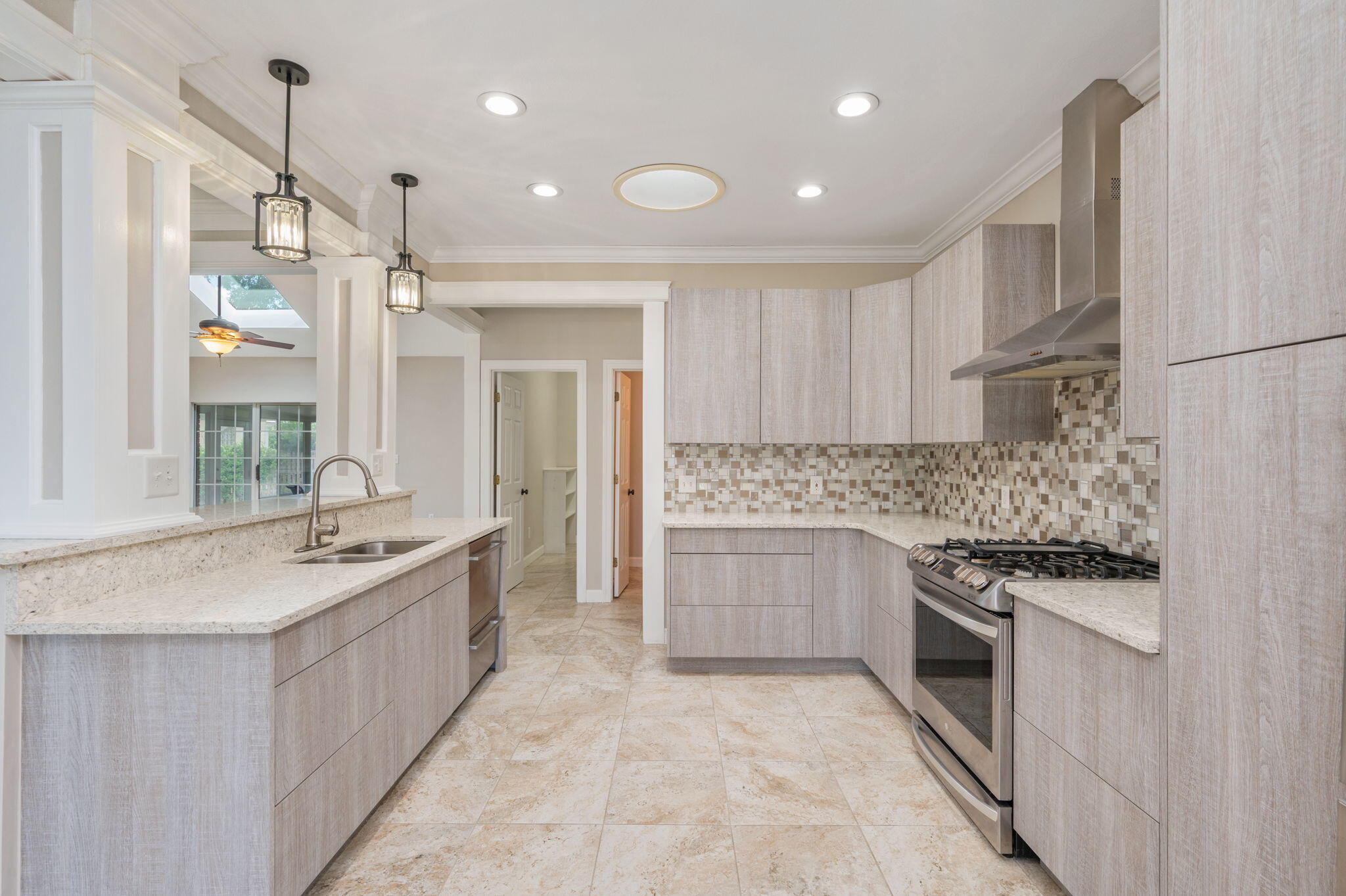 Why wait to build when you can own a luxury custom home that's truly better than new? Every detail of this exceptional residence has been carefully upgraded, offering a level of quality, perfection, and style that's difficult to replicate. From the moment you arrive, the decorative brick accents, stone paved curb appeal, expansive front porch and desirable setting among luxury homes make a lasting impression. Inside, elegant tile flooring flows throughout the home. Plantation shutters, quality fixtures and neutral walls accent the raised ceilings and natural lighting. Kitchen is complemented by custom magnetic touch cabinetry, pot drawers, granite countertops, opulent tile backsplash, new appliances including dual zone dishwasher and stand-alone range hood, and a deep designer kitchen sink for everyday functionality.  Additional bedrooms are spacious and bathrooms are meticulous with tile surrounds and fixtures, including the bonus guest ½ bath. Master bedroom is spacious with spa-inspired ensuite. A true showpiece, featuring an oversized walk-in shower with a sleek glass enclosure and stunning custom tilework that delivers elegance. Dual vanities and added built-in custom cabinetry provide abundant counter space and storage, making busy mornings easy while offering the feel of a luxury resort. This home features paid-off solar panels, impact-resistant windows, seamless gutters, and a Halo LED whole-home air purification system integrated with the HVAC, providing enhanced energy efficiency and purified indoor air. Enjoy tranquil water views from your own front porch while living in one of the area's most sought-after neighborhoods, surrounded by upscale homes. Bonus two car garage and additional concrete parking, with added back-yard patio makes the yard a southern dream.  Privacy fencing, live oak trees, full sprinkler system re-drilled in 2021, 2025 sprinkler well pump, French drains, gutter systems, annual renewable termite bond, and covered porches accent the exterior. Neighborhood offers boat docking, fishing lagoons, parks, and bay-front water access. Every enhancement has already been completed, allowing you to simply move in and enjoy the exceptional craftsmanship, premium finishes, and timeless elegance this remarkable property has to offer.