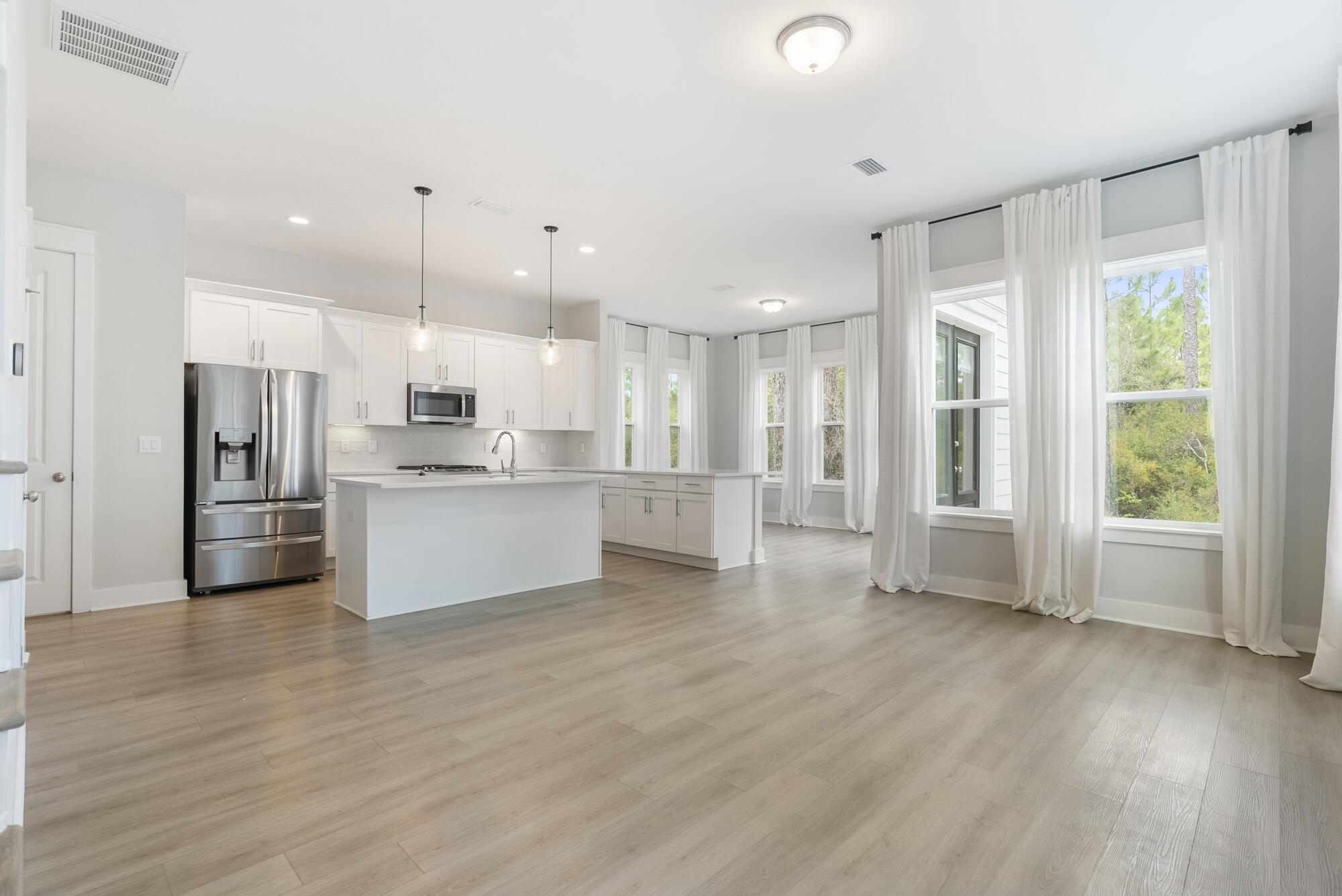 Discover an exceptional opportunity in Church Street Landing--one of the community's most private homesites, nestled among natural pines and thoughtfully designed for modern coastal living. This 3-bedroom, 2.5-bathroom home offers 1,848 square feet of beautifully appointed space with an open-concept layout that fills the home with natural light.

The chef's kitchen features quartz countertops, a gas range, and an expanded pantry--perfect for cooking and entertaining. Elegant upgrades include floor-to-ceiling window treatments, luxury vinyl plank flooring, ceramic tile, and custom finishes throughout.