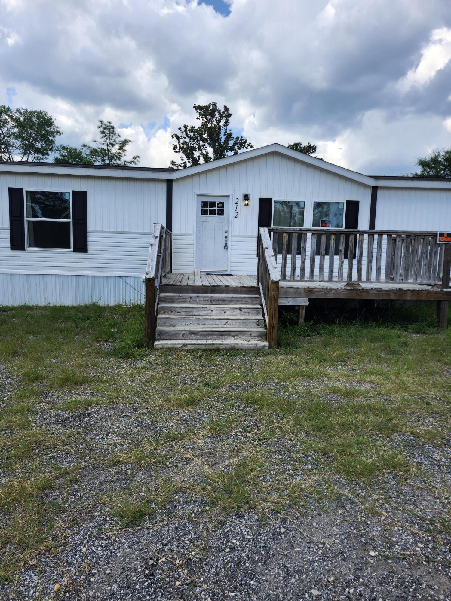 This Move-IN-Ready 3/2 features a great room with an open floor plan where the family can all be together. This home offers a perfect blend of comfort and charm with plenty of indoor and outdoor space. 
Large wooden decks on both the front and back of the home with an additional wheelchair ramp, a fenced backyard, and pretty grass, this home is ready to go. Washer & Dryer can convey with sale but have no value if the buyer wants them.    
This property provides an inviting outdoor oasis where you can easily entertain friends and family, while 4 dedicated parking spaces ensure convenience for all. This private back yard  has a huge deck perfect for BBQ's and summer fun. The master bedroom has an amazing ensuite with double vanity sinks with an off the floor cabinet, and 2 walk in closets in the room.  The shower has a low entry threshold for handicapped accessible chairs.  Built in 2022 Roof, hot water heater, electrical, & HVAC are inspection ready!! This home has been professionally cleaned and is waiting to be a home again.
