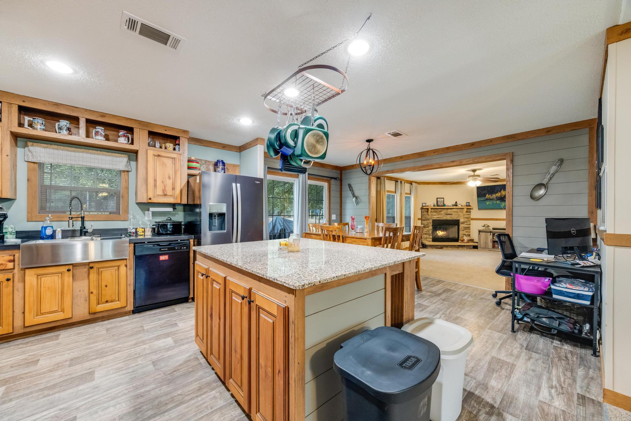 2 Acres! Spacious manufactured home on a quiet country road. Features 2 large living rooms, large kitchen, all appliances stay. Primary suite has it's own master bath and closet.