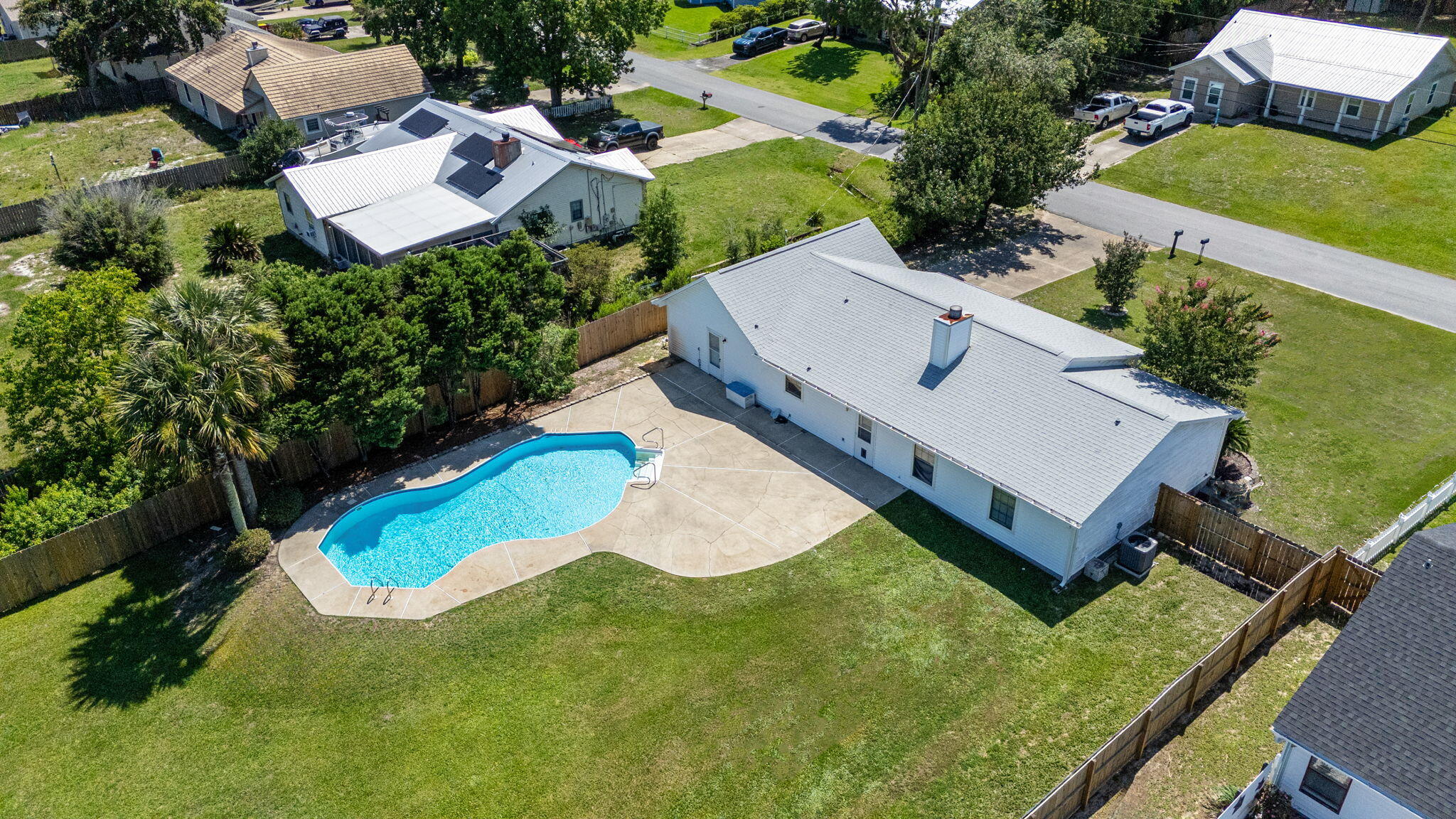Pool home on nearly half an acre with a large workshop and no HOA! Enjoy peace of mind with major updates already completed, including a 2021 roof, 2024 HVAC system, and 2023 water heater. Ideally located in the heart of Navarre, this 3-bedroom, 2-bath ranch-style home is just minutes from Navarre Beach and offers convenient backroad access to Publix, local restaurants, and shopping. Highway 87 and I-10 are also nearby for an easy commute to Pensacola. Inside, you'll find a comfortable and functional layout featuring a spacious living room with a beautiful stone fireplace that adds warmth and character to the space. The large eat-in kitchen provides plenty of room for everyday living and entertaining, while the updated bathrooms, interior laundry room, and 2-car garage add convenience and practicality. Step outside to your own private backyard retreat. The open patio overlooks the sparkling pool, creating the perfect setting for relaxing, entertaining, and enjoying Florida's sunshine. The privacy-fenced backyard offers plenty of room to spread out, and the large workshop provides exceptional space for storage, hobbies, projects, or recreational equipment. With a desirable location, major system updates, generous outdoor space, and no HOA restrictions, this property offers the flexibility and lifestyle you've been looking for.
