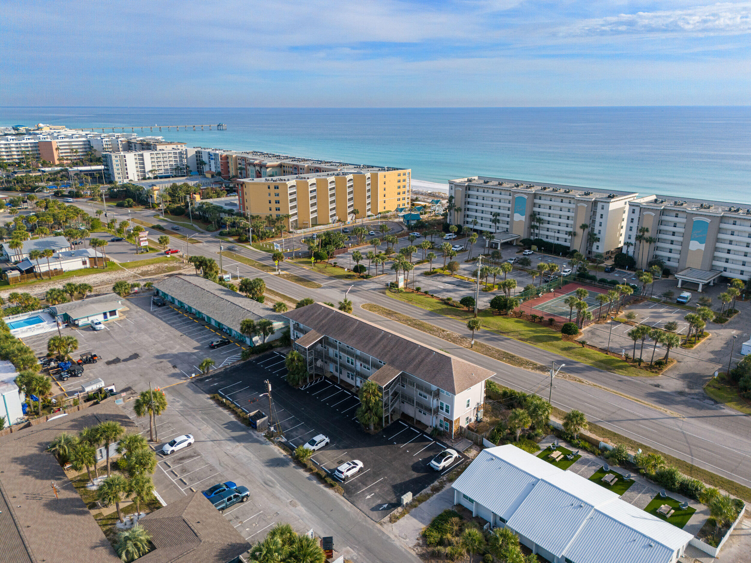 Beachside living without the beachside price tag. Located directly across from the Gulf inside the charming 15-unit low-density Island Gardens community, this condo offers the best of low-maintenance ownership with high-value potential. With easy access to multiple public beach entrances just steps away, this property works beautifully as a short-term rental, long-term rental, or personal getaway.
The interior has been thoughtfully refreshed, starting with a light, bright kitchen featuring granite countertops, stainless steel appliances, upgraded cabinetry, and an eye-catching backsplash. The primary bedroom includes a private half bath with a brand-new vanity for added convenience. It's a fresh space ready for your vision! Outside, the covered balcony looks out over Santa Rosa Boulevard and captures a subtle Gulf glimpsejust enough to remind you why you're here.

Private, walkable, and flexiblethis condo delivers coastal freedom without the chaos.