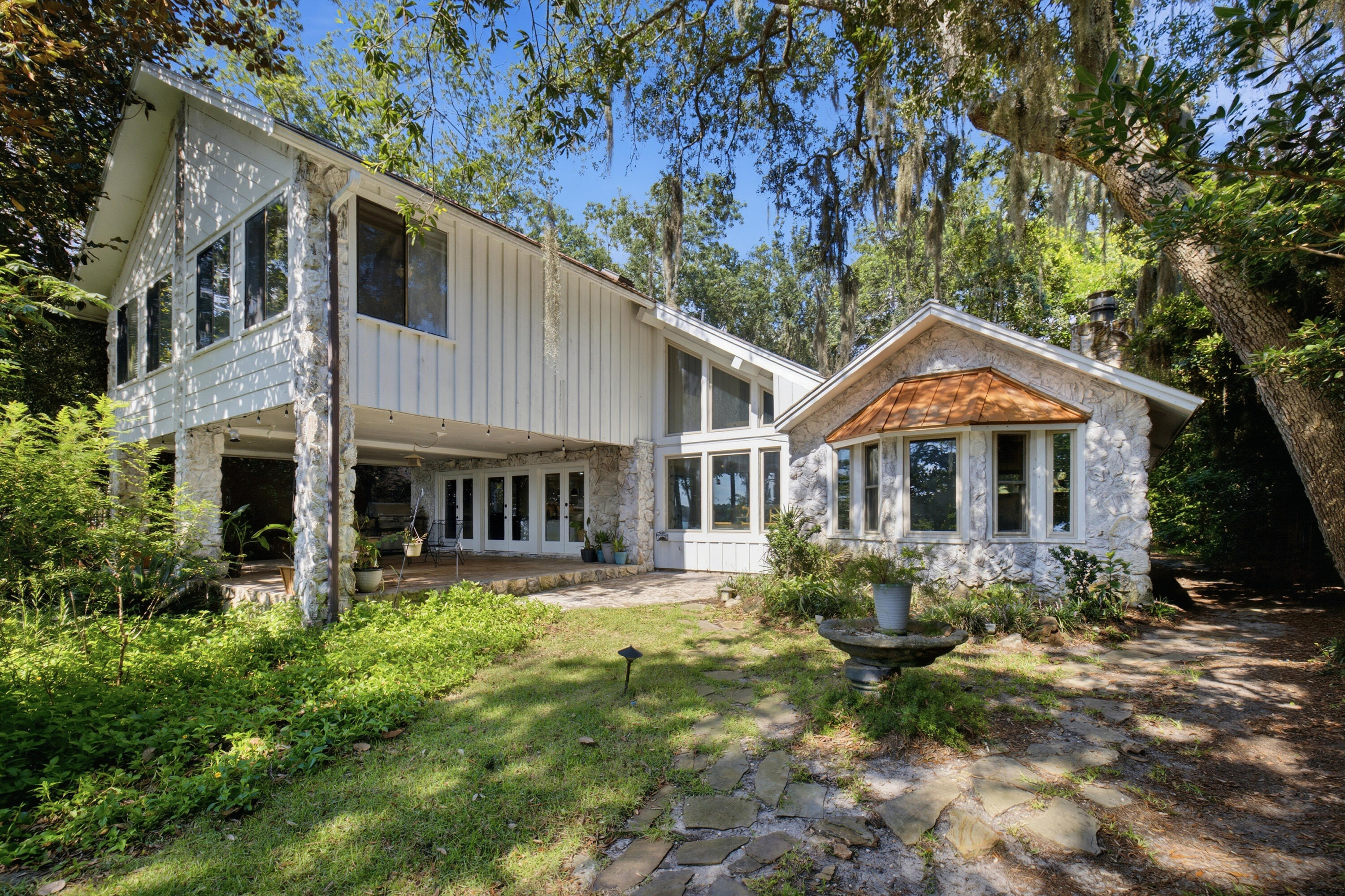 WATERFRONT HOME with BREATHTAKING SUNSETS!!!! Come view this Beautiful 5 bedroom, 4-full, 2-1/2 baths home with a personal office or gym room.  Don't forget the detached 3 car garage with 1 bedroom and half bath above. Perfect for a college student or a media room. This home was made for entertaining and the avid boater.  Enjoy 3 boats lifts. The 3rd lift was added in 2024 (20,0000) lb. lift. In July. 2026 the 4x37 access to pier and 48x36 covered boathouse with 2 slips and interior catwalks, upper deck and covered deck with boathouse were sealed with 10-year Valspar stain & sealer.   In 2023, all new ceiling fans, new light fixtures, toilets, sinks, countertops and vanities in bathrooms, bathroom mirrors, remodeled shower in master, ceilings scraped throughout and painted, shiplap added in master bedroom, master bathroom, other bathrooms, ''new hardware and faucet in the kitchen, master shower, guest shower, doors, sinks. Other upgrades in 2023,  the home received all new Interior and Exterior paint, new upper cabinets in 2 of the bathrooms, tile flooring in the lower hallway. 2 baths and laundry room.  A metal roof was installed on the home in 2012. In 2016 the kitchen was remodeled and more updates added in 2023.  In 2016 new roof was installed on the detached garage, 2017 electrical wiring and gas were installed with a whole house generator. Updates and controllers were added to the generator in 2022. In 2019 11 windows in back of the home were replaced with high impact glass.  The kitchen and den open up through French doors to a 23x40 covered back porch.  Whether you're having a cup of coffee or ending the day with a glass of wine, this is a perfect setting! There's an extended gas grill in place for all your cookouts and the area is large enough for several sets of patio furniture.  If you decide to take the party to the docks, you'll enjoy the beach area for everyone to play, float and put the paddle boards or kayaks in the water. Enjoy two separate decks with some covered area by the boat house for those who would like to be on the water, but need some shade. Don't worry about storage for all the floats.  The boat house is big enough to store your fishing gear, crab traps, floats and enjoy a quick shower before coming back up to the house.  The outside shower is located up on the deck next to the boathouse.  Everything is covered! Don't forget about all the dolphins that you'll get to see along with all the other marine life. This is a Very Special property in a very sought out area in Poquito Bayou. Minutes away from Eglin, and Special forces. It sits further back in the bayou yet minutes away from Crab Island, shopping and restaurants by boat. Upkeep of the yard is made easy with the updated sprinkler system in 2023. Call today for a viewing!