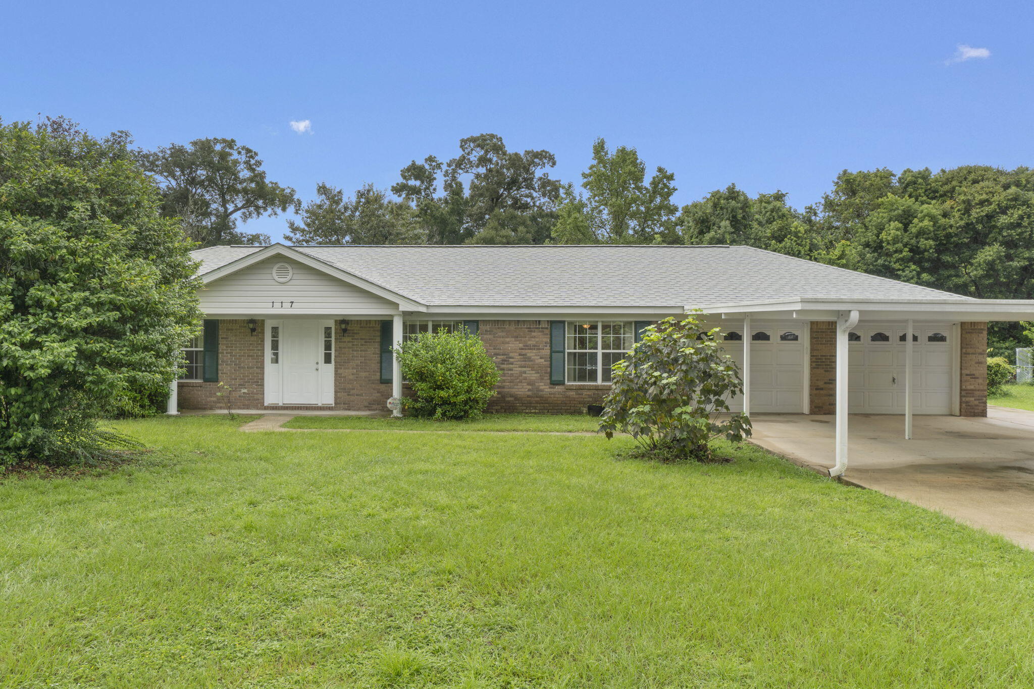 This adorable 3 bedroom, 2 bathroom home in the Oakfield Acres subdivision in Pensacola is move-in-ready and centrally located - just minutes away from schools, shopping, restaurants and quick and easy access to the interstates for commuting! This one owner brick home is situated on a generous sized lot and features a 2024 roof, a whole house - natural gas powered - Kohler generator, a 2 car carport leading to the 2 car garage and an extended concrete pad on the side of the house that goes to the gate to the backyard. Inside, you'll find fresh interior paint and tiled flooring throughout the home. Featuring a formal dining room, eat-in kitchen, living room with electric fireplace, and a  versatile flex space at the front of the home that could be utilized as an additional living room/den,