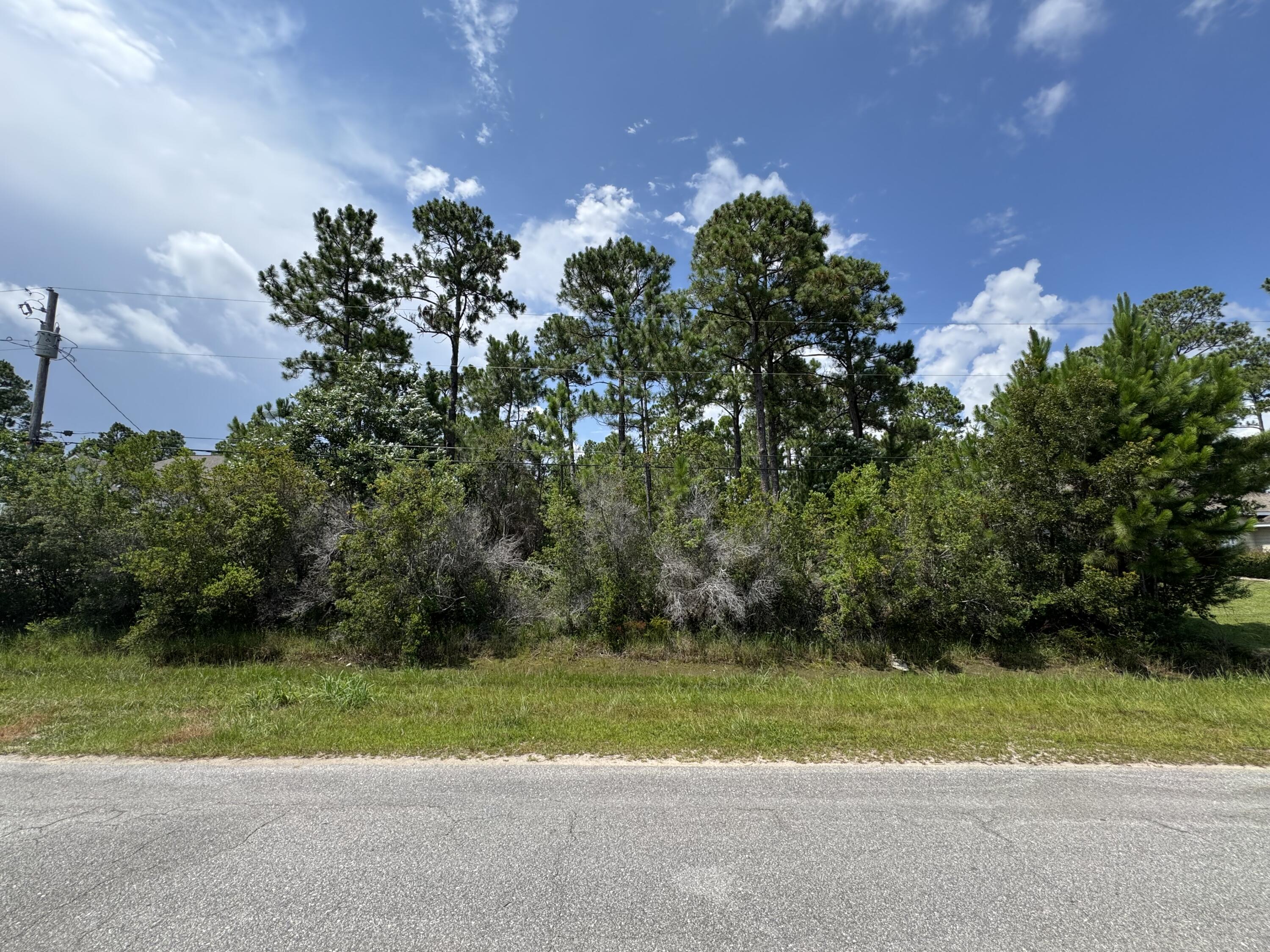 Build your dream home in one of Navarre's most desirable neighborhoods! This 0.459-acre residential homesite is located in the sought-after Holley by the Sea subdivision, offering an excellent setting to build a custom home in an established neighborhood with ongoing new construction. As a Holley by the Sea property owner, you'll enjoy access to a 48-acre park and recreation center featuring three swimming pools, a full fitness center, eight lighted clay tennis courts, pickleball courts, basketball courts, a walking trail, fishing pier, boat ramp, beach area, playground, sauna, steam room, the Beach House, picnic pavilions, and campground facilities. Conveniently located just minutes from Navarre Beach, shopping, dining, schools, Hurlburt Field, and Eglin Air Force Base, this property offers the perfect blend of neighborhood living and Emerald Coast convenience. Whether you're planning to build your forever home, a second home, or invest in one of Northwest Florida's most sought-after neighborhoods, this homesite is ready for your vision.
