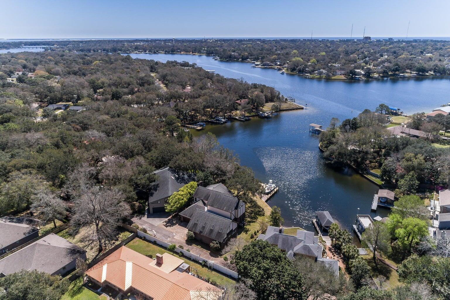 EXQUISITE Custom Tudor-Style Protected Waterfront Home with Stunning Views. X Flood Zone!! Roof 2023, Kohler Generator 2023. Welcome to your Dream Home nestled on a private, tree-lined drive in a tranquil, protected bayou. This exquisite 3-bedroom 3.5 bathroom residence offers a perfect blend of Elegance, Comfort, and Breathtaking Natural Beauty. Step inside to discover spacious living areas bathed in natural light from large windows that provide stunning views of the water. Expansive living room is perfect for both relaxing and entertaining. The master suite serves as a private retreat, complete with an en-suite bathroom and a generous walk-in closet. Each additional bedroom is equally inviting, with natural light and serene views, and the bathrooms are thoughtfully designed. And a POOL!