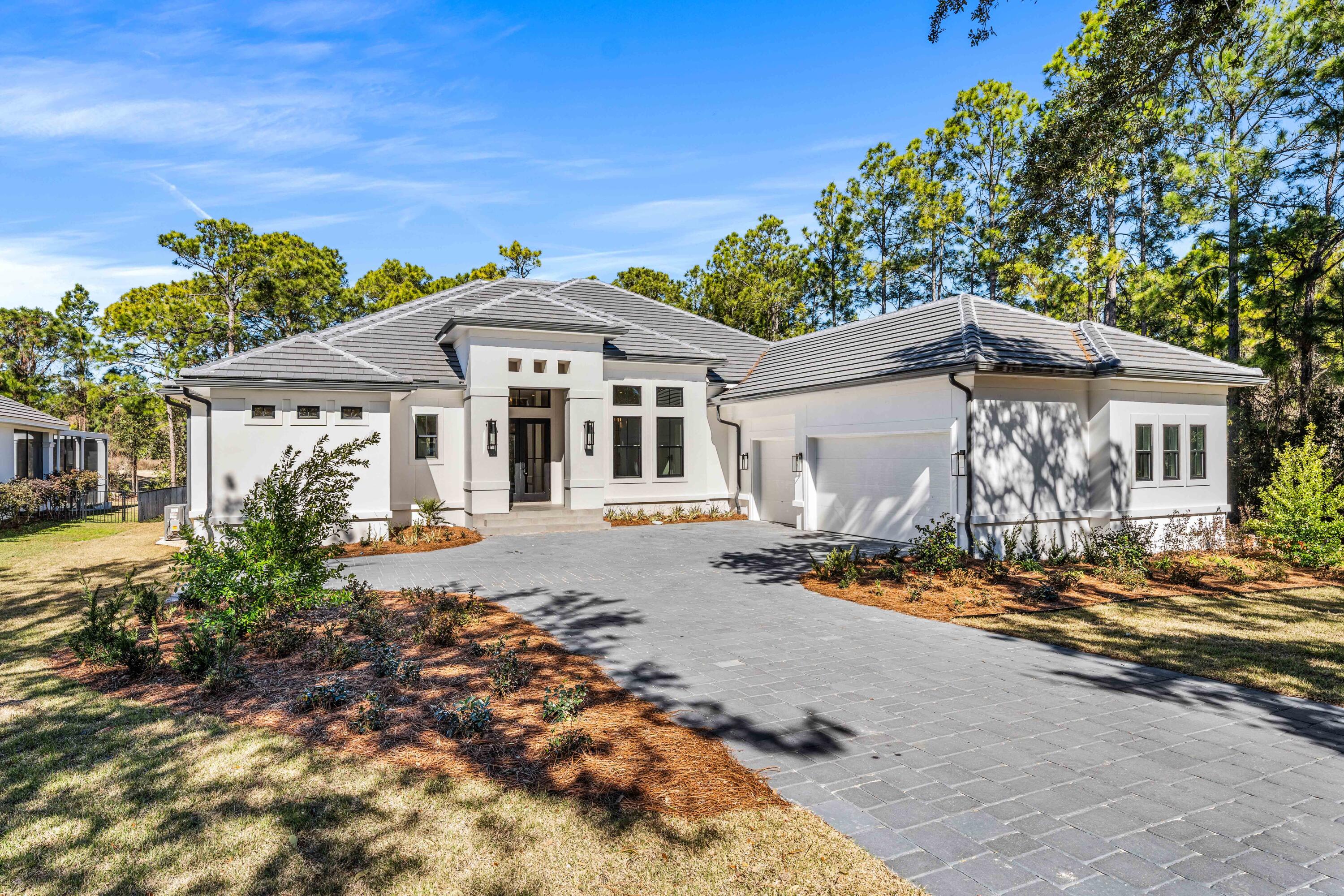 Welcome to 438 Regatta Bay Boulevard -- an exceptional new construction residence perfectly positioned on nearly half an acre along the 1st hole of Regatta Bay's championship golf course. This thoughtfully designed single-level home offers 4 bedrooms and 3.5 baths, blending refined finishes with effortless livability.
A dramatic 16-foot foyer entry immediately sets the tone, drawing your eye through the home to the expansive outdoor living space beyond. Designed for both entertaining and everyday comfort, the nearly 1,000 square feet of covered outdoor living creates a seamless indoor-outdoor experience overlooking the fairway. The chef's kitchen is equipped with premium Thermador appliances and opens naturally into the main living areas, creating an ideal setting for hosting or quiet evenings at home. Privately situated, the primary suite spans the entire left wing of the residence -- a true retreat offering space, privacy, and tranquility.
Additional highlights include a spacious three-car garage with decorative epoxy chip flooring, an expansive walk-in attic for exceptional storage, 4 zone Sonos sound system, and convenient golf cart access to the Regatta Bay clubhouse, Legendary Marine, Destin Commons, and more.
A rare opportunity to own a one-level new construction home in one of Destin's most sought-after gated golf communities.
