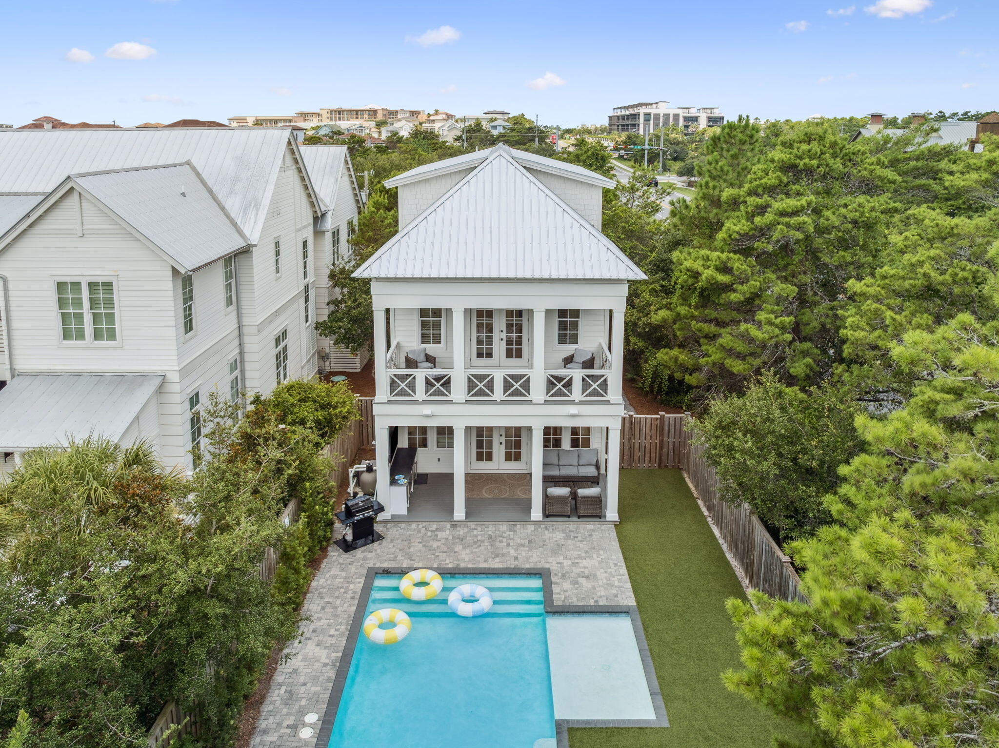 INVESTORS: Rentals booked through August! Take advantage of your investment already set with bookings to transfer.
Luxury meets coastal charm in this fully furnished, turnkey retreat south of Scenic Highway 30A, offering five en suite bedrooms plus a bunk room, private pool, and easy beach access just steps away. Designed to sleep up to 16, this home delivers the ideal blend of lifestyle, comfort, and rental-ready flexibility. 
Set on a corner lot in a highly desirable South of 30A location with no HOA, the residence showcases Southern coastal architecture elevated by modern finishes throughout. Expansive full-width front and rear porches, along with a covered poolside terrace and outdoor bar, create exceptional indoor-outdoor living, perfect for entertaining and year-round enjoyment. Inside, soaring ceilings, hardwood flooring, and sun-filled living spaces welcome you into an open, inviting floor plan. The gourmet kitchen features quartz countertops, premium stainless steel appliances, and generous prep space suited for everything from casual beach days to hosting larger gatherings. A first-floor guest suite, multiple balconies, and a garage add convenience and flexibility rarely found at this level.
Tucked away from heavier foot traffic, the home enjoys access to a quiet neighborhood beach boardwalk just down Sand Dunes Road, offering a peaceful path to the sugar-white sands and emerald waters that define 30A. Conveyed fully furnished, including a golf cart, this property is truly rental-ready and well-positioned for personal enjoyment or short-term rental use.
A rare opportunity to own a south-of-30A coastal home with private pool, strong rental appeal, and immediate beach access--all just moments from the dining, shopping, and charm that make 30A one of the most sought-after coastal destinations in the country.