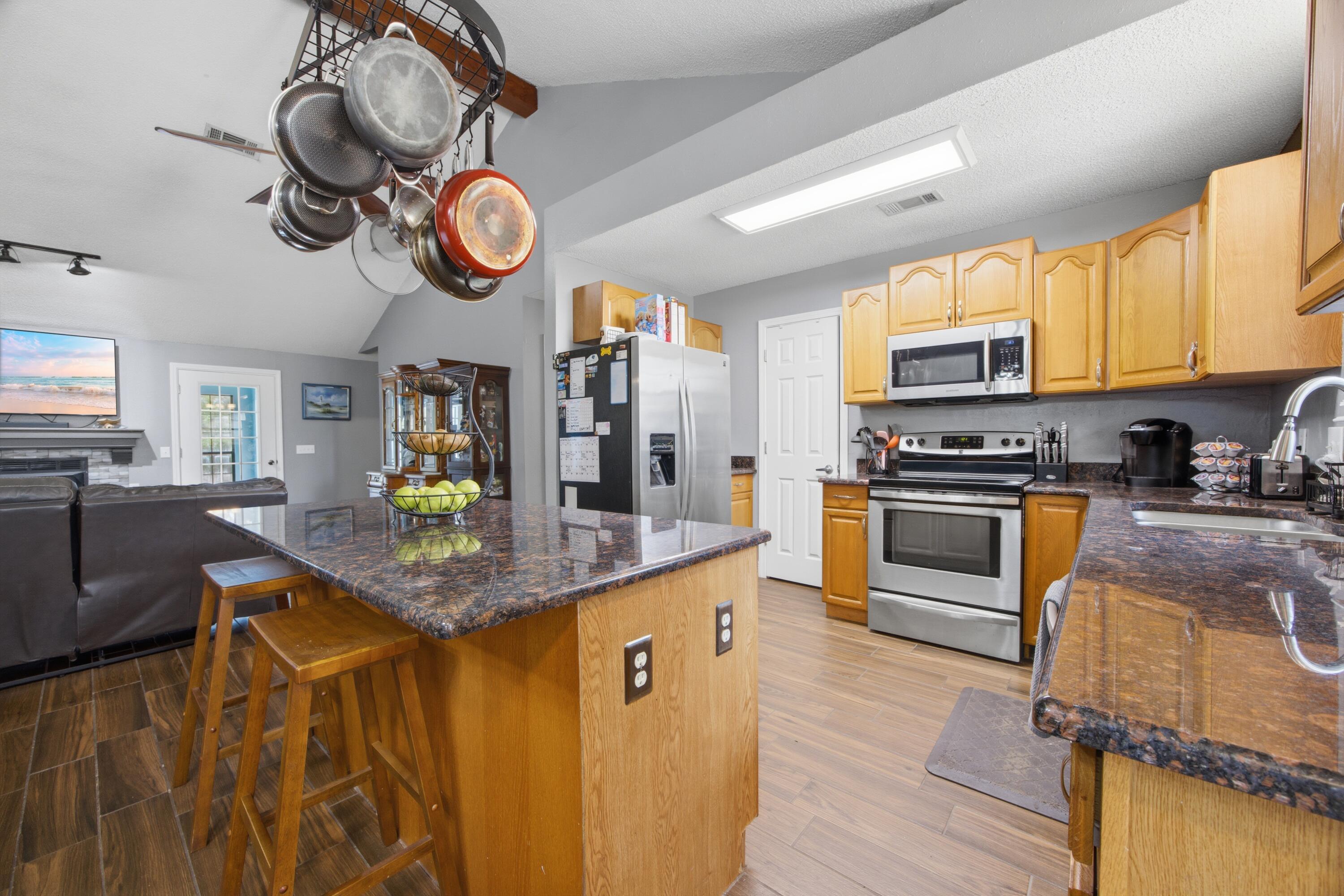 Experience the perfect blend of country charm and modern convenience at this exceptional property. Nestled on 3.84 acres, this home offers plenty of room to spread out while still being close to everything you need. Located just minutes from the Ray Lynn Barnes Boat Ramp, you'll have quick access to the Shoal River for boating and outdoor recreation. Commuters will appreciate the easy access to Interstate 10 and close proximity to town. Inside, you'll find a thoughtfully designed open-concept layout with wood-look tile flooring throughout the main living spaces and a split-bedroom floor plan for added privacy. The kitchen is the heart of the home, featuring granite countertops, stainless steel appliances, and a large island with bar seating ideal for gatherings and everyday living. A fresh coat of paint gives the kitchen a bright, updated feel. Enjoy year-round relaxation in the enclosed Florida room overlooking your private backyard retreat, complete with a large in-ground chlorine pool. Need extra space? A finished loft and enclosed garage provide the perfect bonus areas for a playroom, office, or guest space. The primary suite is designed for comfort, featuring a spacious walk-in closet, dual vanities, a glass-enclosed walk-in shower, and a soothing whirlpool tub. Outdoors, the possibilities are endless. The property includes a fenced corral ready for livestock and a privacy-fenced yard with a new double gate which is perfect for securely storing a boat or RV. A 2021 roof replacement adds lasting value and peace of mind. If you've been searching for space, versatility, and a touch of Florida lifestyle, this one checks all the boxes.