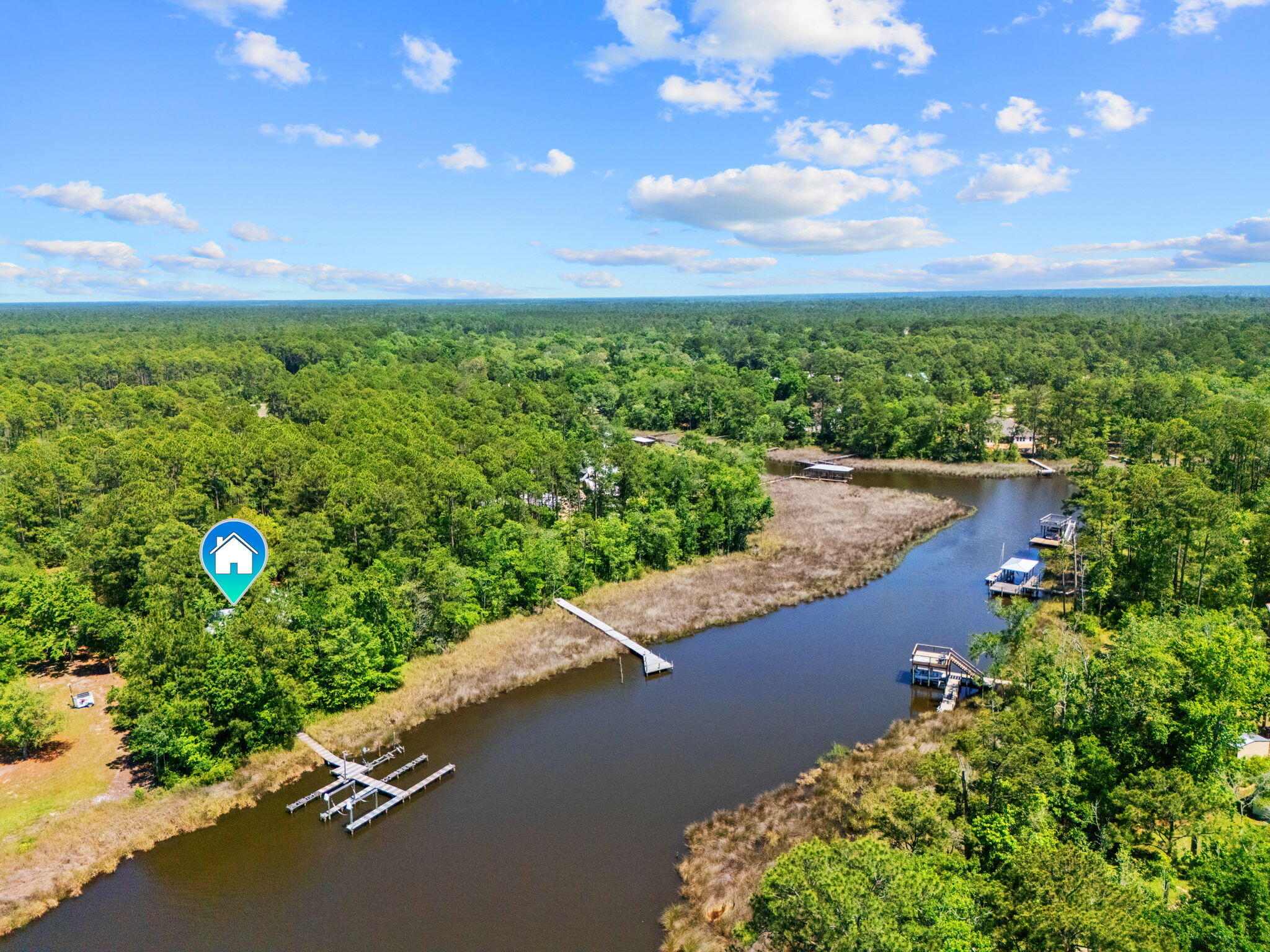 MOTIVATED SELLER - BRING ALL OFFERS! Enjoy waterfront living on beautiful Mallet Bayou with approximately 100 feet of water frontage and direct access to boating, fishing, kayaking, Choctawhatchee Bay, and the Intracoastal Waterway. This unique property features a private dock with four slips and a boat lift rated for up to 3,000 lbs.

The home offers a spacious screened porch overlooking the water, a wood-burning fireplace, double-pane windows, foam attic insulation, durable Hardie board siding, and a new metal roof installed in 2024. In addition to the attached two-car garage, the property includes a detached garage/workshop, RV pole barn, carport, greenhouse, and mower shed, providing ample storage and workspace.

With no HOA and unrestricted use, this property offers incredible flexibility for boaters, hobbyists, RV owners, and those seeking room to spread out. Conveniently located near Freeport's shopping, dining, marinas, schools, and just a short drive to the beaches of South Walton.

Motivated seller says bring all offers! This is a rare opportunity to own a well-equipped waterfront property with endless possibilities on Mallet Bayou.