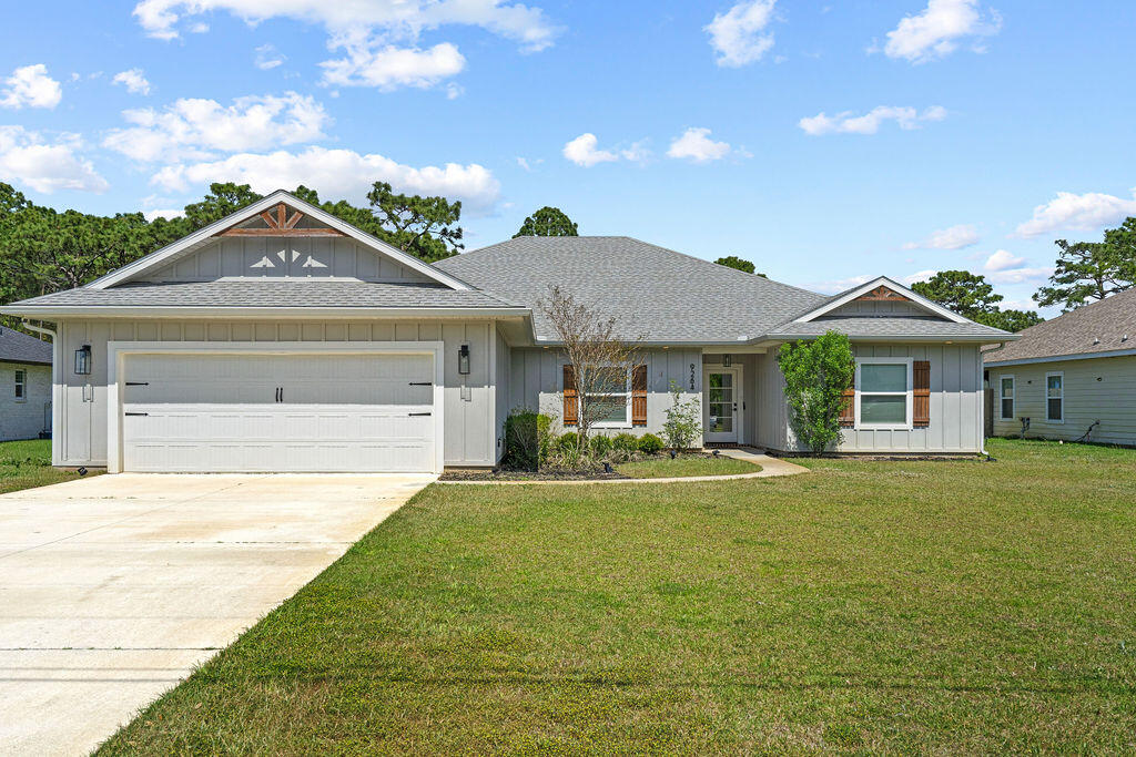 Welcome to your private slice of Navarre living-where space, style, and thoughtful design come together on a beautiful large lot. This stunning 5-bedroom, 3-bath home offers an abundance of room to spread out, featuring an open-concept layout paired with a split floor plan that provides both functionality and privacy. From the moment you walk in, you'll notice the attention to detail, including a trey ceiling in the living room, a built-in electric fireplace with shiplap accent, and seamless Cortec LVP flooring throughout. The kitchen is truly the heart of the home and designed to impress--complete with a gorgeous range hood, 30-inch flat top electric stove with with pot filler, built-in microwave and oven, cypress floating shelves, all-wood shelving in the pantry, and a convenient pull-out trash cabinet. The breakfast bar and eat-in dining space make it perfect for both everyday living and entertaining. The spacious primary suite is a true retreat, featuring private access to the screened-in patio, a spa-like en suite with a large walk-in tile shower, soaking tub, and an oversized walk-in closet with built-ins. In addition, a separate guest suite with its own private bathroom offers the perfect setup for visitors, in-laws, or added privacy for household members. Additional highlights include a well-appointed laundry room with a built-in coat rack and storage, perfect for keeping all your beach essentials organized. Step outside and enjoy the curb appeal and craftsmanship with Hardie board siding, cypress shutters and trusses, a fully sodded yard, and a privacy fence-offering both beauty and peace of mind. The oversized 24x24 garage provides plenty of space for vehicles, storage, or hobbies. If you've been looking for a home that offers space to live, entertain, and unwind--all while enjoying the lifestyle Navarre is known for, this one checks all the boxes.