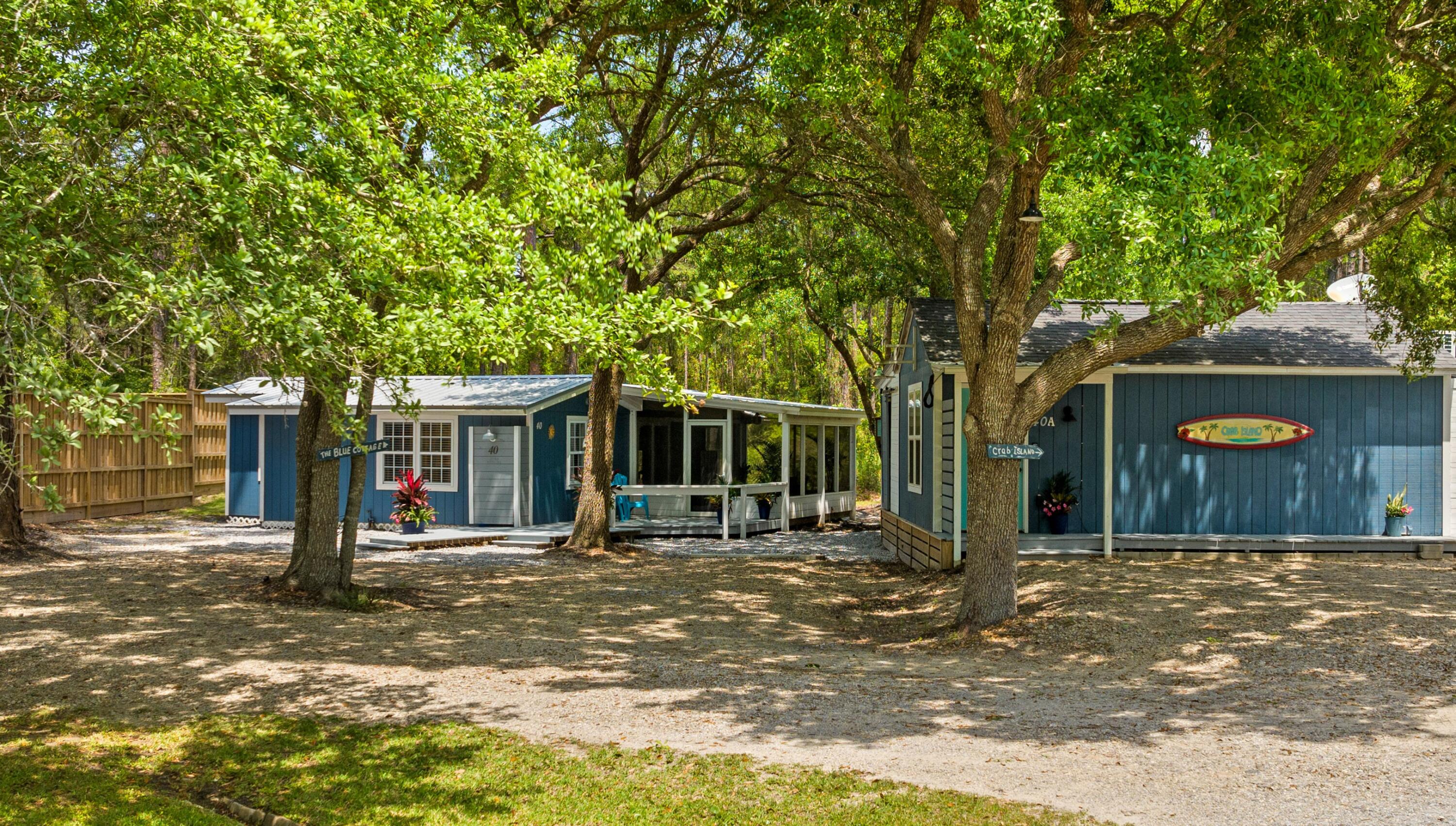 INVESTORS, PRIMARY RESIDENTS & MULTI-GENERATIONAL BUYERS--Discover an exceptional opportunity to own one of Santa Rosa Beach's most versatile properties-2 HOMES for the price of ONE! Just minutes from the sugar-white beaches of South Walton and Scenic Highway 30A, this unique coastal compound is zoned for both short-term and long-term rentals, offering incredible flexibility for investors, owner-occupants, workforce housing, or multi-generational living.

Situated on a 0.28-acre lot and bordered by a 255-acre conservation buffer that will never be developed, the property features two fully furnished coastal cottages, a 30-amp RV hookup with sewer connection, ample parking, no HOA, and room to add a pool, spa, garden, or expanded outdoor living spaces.

One of the property's most remarkable qualities is how it lives far larger than its square footage suggests. Expansive screened porches, generous decks, and thoughtfully designed outdoor spaces blur the line between indoors and out, creating an inviting coastal atmosphere where every square foot is maximized. Whether enjoying your morning coffee on the porch, entertaining friends outdoors, or unwinding after a day at the beach, the seamless indoor-outdoor flow becomes an extension of the living space.

The Blue Cottage offers 2 bedrooms, 1 bathroom, 868 square feet of heated and cooled living space plus a 178-square-foot screened porch, totaling 1,046 square feet of usable space.  Extensive improvements include a 2023 metal roof, new kitchen appliances, new kitchen island, countertops, flooring, interior and exterior paint, water heater, washer and dryer, and a new laundry room door. The screened porch features a flat-screen TV and opens to a grilling deck, while plumbing is already in place for a future outdoor shower, pool, or spa. The most recent long-term lease generated $2,125 per month, while the cottage produced approximately $29,000 in gross short-term rental income during 2023.

Privately tucked away on the opposite side of the property, the detached "Crab Island" Studio Cottage, built in 2014, creates its own secluded retreat behind an 8-foot privacy fence. Perfect for pets, guests, or future outdoor enhancements, the fenced yard offers ample room for a pool, hot tub, or additional entertaining space. The studio features 350 square feet of interior living space complemented by an impressive 236-square-foot screened porch, where large sliding glass doors create a true indoor-outdoor living experience. Designed for coastal entertaining, the porch includes an outdoor kitchen with a wet bar, sink, mini refrigerator, storage, and ceiling fans, while the wraparound deck and outdoor shower make beach days effortless. Inside, the studio offers a kitchenette, an updated bathroom with a new shower, and flexible living space ideal as a guest house, artist's studio, home office, hobby room, fitness room, private retreat, or mother-in-law suite. The most recent long-term lease generated $1,675 per month, and the studio produced approximately $19,000 in gross short-term rental income during 2023.

With combined long-term rental income of $3,800 per month ($45,600 annually), this property offers outstanding flexibility. Live in one cottage while renting the other, lease both for investment income, accommodate extended family, create workforce housing for local professionals, or simply enjoy a private coastal retreat with supplemental rental potential.

Conveniently located just minutes from Scenic Highway 30A, Grand Boulevard, Topsail Hill Preserve State Park, Sacred Heart Hospital, shopping, dining, entertainment, and South Walton's world-famous beaches, this property combines privacy, versatility, and established income potential in one exceptional offering.

More than just two cottages, this is a thoughtfully designed coastal compound where lifestyle, flexibility, and investment opportunity come together--offering possibilities that are increasingly rare to find in Santa Rosa Beach.