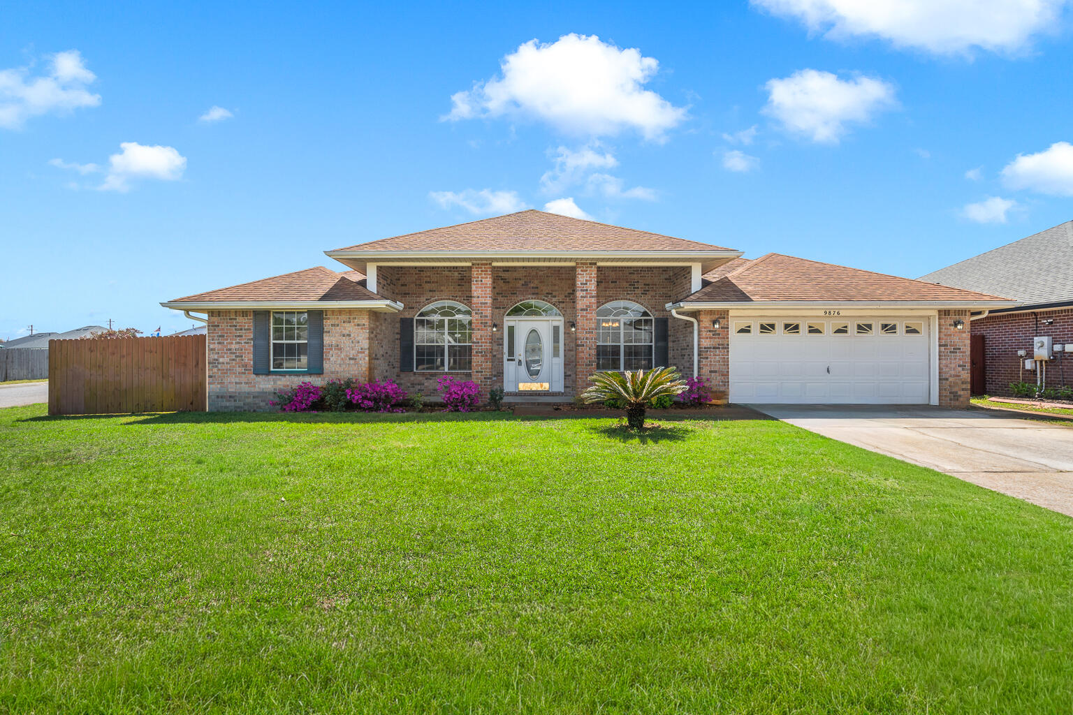This all-brick contemporary home offers a well-designed 4-bedroom, 2-bath layout with inviting curb appeal. Situated on a corner lot, the property features a functional open and split floor plan, providing both connectivity and privacy. Inside, you'll find a versatile office or formal dining space, raised ceilings, and thoughtful architectural details throughout. The kitchen is equipped with a breakfast bar that opens to the dining area, a deep stainless steel sink with an upgraded faucet, and a full suite of stainless steel appliances, including the dishwasher, refrigerator, microwave, and electric range. A large pantry and ample cabinet space provide excellent storage, while updated lighting and ceiling fans complement the space. The primary suite includes a trey ceiling, ceiling fan, spacious walk-in closet, double vanity, whirlpool tub, and a separate shower. Additional bedrooms are conveniently located near the main living area, with two sharing a full bath. A separate bedroom offers added flexibility and includes direct access to the covered back porch. Both the living area and primary suite also provide access to the outdoor space. Conveniently located near Highway 98, with easy access to local amenities, and just a short distance to Navarre Beach. Move-in ready and well-maintained, this home is ready for its next owner to enjoy.