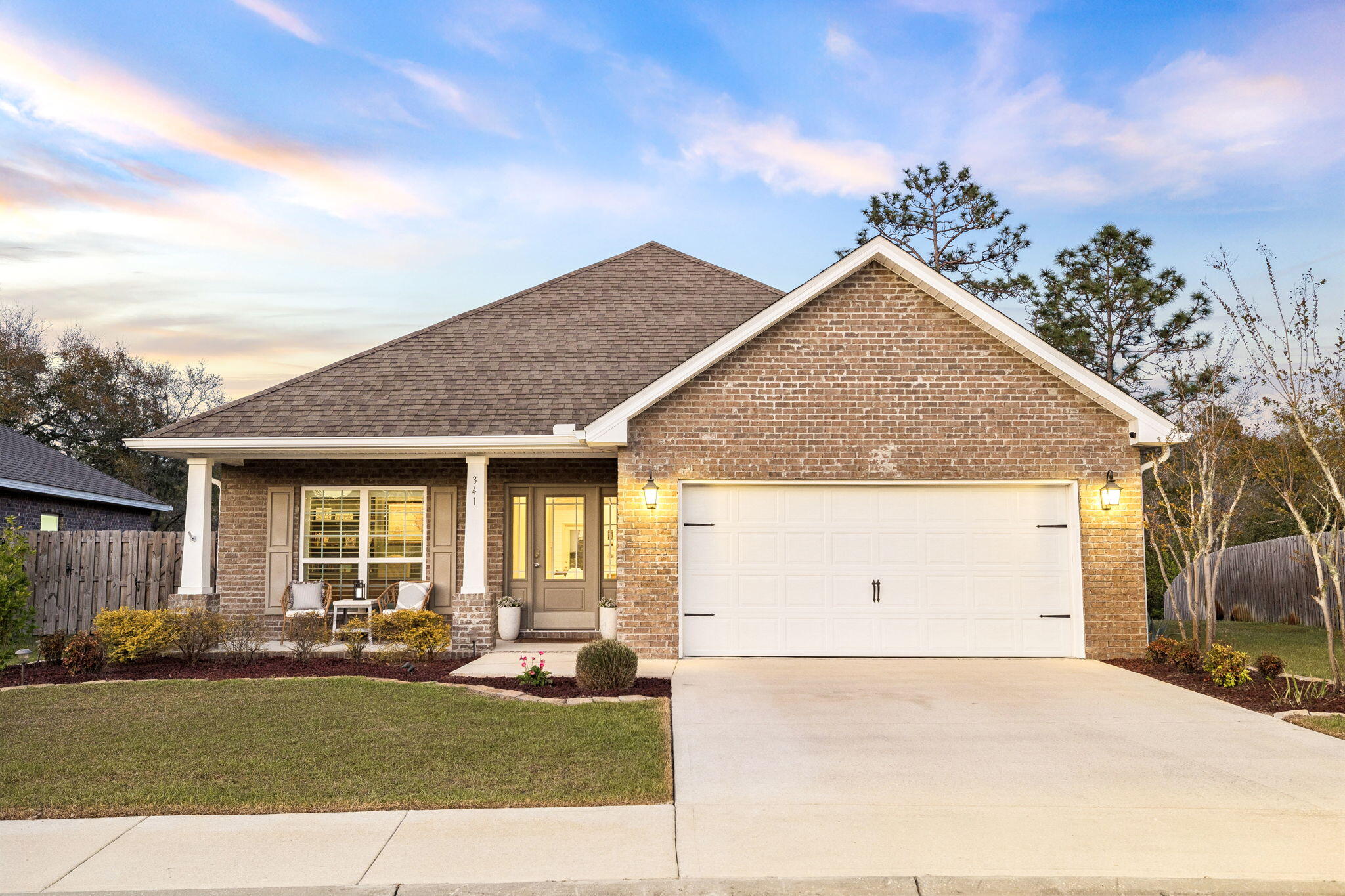 Welcome to premier coastal living in Santa Rosa Beach! This exceptionally crafted, one-story residence has been designed to host extraordinary memories near 30A. Positioned on a scenic lily pond and offering a quarter-acre lot, the home displays privacy and fantastic outdoor living spaces. Step inside to explore a perfect floor plan with three-bedrooms, an office and a tremendous living room. The office has been customized with built-in bookcases, gorgeous shiplap and tons of storage. The chef's kitchen features crisp white cabinets along with high-end appliances and a stunning antique pantry door. Enjoy the lovely dining space underneath rich wood beams. The living room is the heart of the home with its captivating stone fireplace, wood mantel and upscale arched built-ins. The light, airy bar showcases a beverage cooler, quartz countertops, white tile backsplash, wood shelving and additional storage. You will notice incredible details such as 5' wainscoting, plantation shutters, high-end light fixtures & unique cabinet hardware. The primary suite offers an exemplary view of the lily pond, a refreshing primary bathroom, and a spacious walk-in closet. The two guest bedrooms have been customized with stunning wall features and have roomy storage closets. Step outside to lounge on your expansive screened-in porch and walk along beautiful pavers to your substantial outdoor fire pit gathering space. 341 Wayne Trail is located in the beautiful community of Peach Creek, close to all of the top schools in Walton County. Capture this stunning home and make wonderful family memories near 30A!