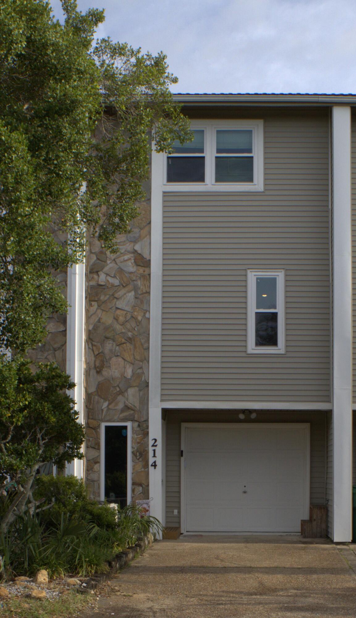Open house Saturday 6-13 and 6-20 from 12 to 3. Welcome to this stunning three-story waterfront townhome on Garnier's Bayou, with a deep-water slip (10,000 lb.) Boat and Jet ski lift with remotes. Perfectly positioned to capture beautiful sunsets and views of the bay and designed for effortless coastal living. Access to Choctaw Bay and Crab Island right out front of your door. The ground level includes a versatile bonus room, ideal for a home office, gym, or guest suite. Currently there is a tenant who would like to stay. And it opens directly to the waterfront patio. Step outside to your private dock. With occasional dolphin sitings. Newer Anderson windows which can withstand 165 mph hurricane winds. Metal roof installed 2005. Master bedroom patio converted for an extra 10 ft of living space.