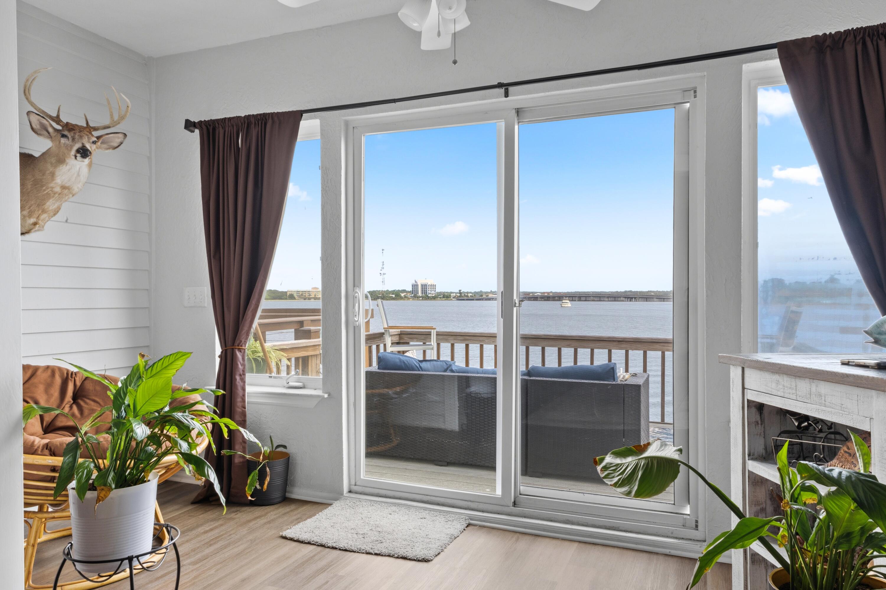 MUST SEE WATERFRONT PROPERTY!! With the additional first story living area on the ground floor, this adds EXTRA square footage to the property. Can be an office, a rental, man or lady cave!!!
Open house Saturday 6-13 and 6-20 from 12 to 3. Welcome to this stunning three-story waterfront townhome on Garnier's Bayou, with a deep-water slip (10,000 lb.) Boat and Jet ski lift with remotes. Perfectly positioned to capture beautiful sunsets and views of the bay and designed for effortless coastal living. Access to Choctaw Bay and Crab Island right out front of your door. The ground level includes a versatile bonus room, ideal for a home office, gym, or guest suite. Currently there is a tenant who would like to stay but is prepared to move with a 30-day notice. And it opens directly to the waterfront patio. Step outside to your private dock. With occasional dolphin sitings. Newer Anderson windows which can withstand 165 mph hurricane winds. Metal roof installed 2005. Master bedroom patio converted for an extra 10 ft of living space.