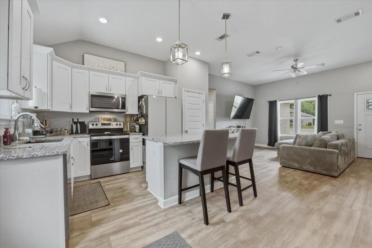 Welcome to this newer 3-bedroom, 2-bath home nestled at the end of a quiet cul-de-sac in North Crestview's Majestic Oaks Vineyards community. Situated on a half-acre lot with no neighbors on one side and generous space between each home, this is the kind of street where kids ride bikes after school and you actually know your neighbors privacy and community all at once. Fenced in back yard. Not all of the .5 acres is fenced. The all brick exterior opens into a spacious open concept floor plan with 10ft ceilings in the main living area, Luxury Vinyl Plank flooring throughout the common spaces, and carpet in the bedrooms. The kitchen is built to impress quartz countertops, white shaker cabinets, stainless steel appliances, a work island with bar seating, and a corner pantry, all flowing seamlessly into the dining and living areas. The owner's suite features double vanities, and a walk-in closet. A large laundry room and double-pane windows add everyday functionality, and a charming front porch gives you the perfect spot to enjoy a quiet morning coffee.  Conveniently located north of I-10 with easy access to Okaloosa County schools.