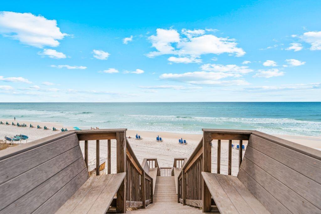 A beautifully reimagined 3-bedroom, 3.5-bath Gulf-front home ideally positioned on approximately .56 acres, extending to the mean high water mark and offering a private beach setting atop a naturally elevated bluff with sweeping Gulf views. Only 50 steps to the beach. 
Designed for both comfort and coastal elegance, the home features an open-concept living area with a coffered ceiling in the great room and abundant natural light. The chef's kitchen is appointed with Viking professional appliances, a large center island, pantry closet, and seamless flow for entertaining. A charming bunk niche adds flexibility for guests, while a full-sized laundry room enhances everyday functionality. a large center island, pantry closet, and effortless flow for entertaining family and guests alike. A charming built-in bunk niche provides additional flexibility, while a spacious laundry room and abundant storage throughout add everyday functionality. Travertine marble flooring spans the main living level, complemented by warm hardwood floors upstairs and beautifully updated baths finished in timeless marble and designer tile selections.
Outdoor living is equally impressive and designed to embrace the Gulf-front lifestyle. The expansive second-floor deck captures breathtaking sunset views and coastal breezes, while the first-level stone patio creates an inviting setting complete with a gas grill, fire pit, outdoor shower, and private beach access just beyond.
Fully enclosed by a concrete perimeter wall and accessed through a gated brick paver driveway, the property offers a rare sense of security and exclusivity rarely found along 30A. Zoned Neighborhood Infill with no HOA, this is a remarkable opportunity to own a private Gulf-front compound in one of the most prestigious and supply-constrained luxury markets on the Emerald Coast.