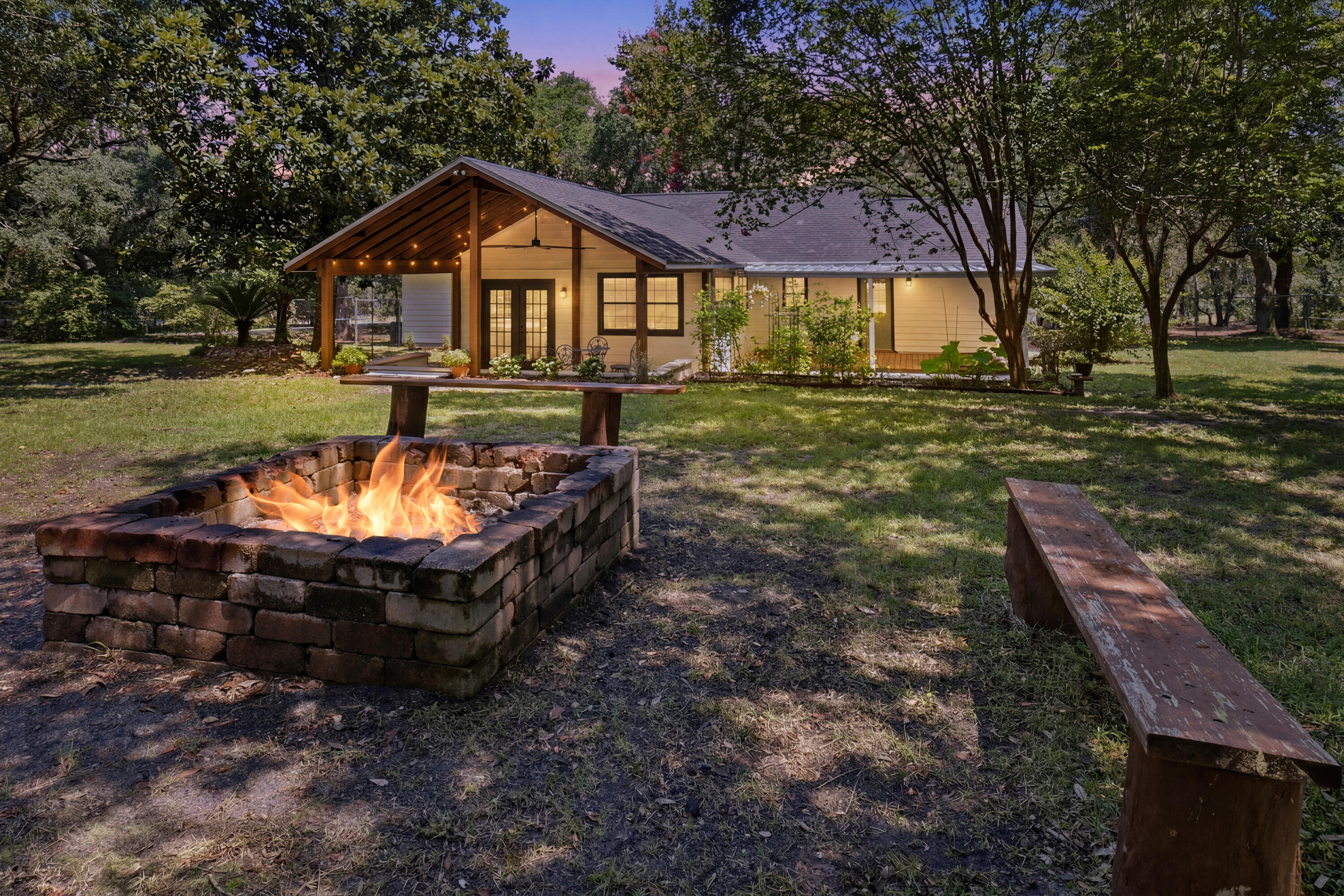 Welcome home to a property that offers something increasingly hard to find: room to breathe, room to grow, and room for the whole family -- however you define it. Tucked behind mature trees on a lot more than twice the size of typical neighborhood parcels, this beautifully updated 4-bedroom, 3-bathroom home paired with a fully-equipped ADU is built for the way people actually want to live today.
Step inside and feel the difference fresh updates make. New paint, new fixtures, and durable LVP flooring flow throughout the home, creating a bright, modern backdrop for everyday life. The kitchen has been beautifully reimagined with new cabinetry, quartz countertops, and updated fixtures -- a space that invites you to cook, gather, and linger.  The heart of the home is a spacious living area anchored by vaulted ceilings and a classic wood-burning fireplace, perfect for cool evenings and cozy gatherings. Just beyond, a generous Florida Room -- also with vaulted ceilings -- extends your living space and opens onto a large covered patio, blurring the line between indoors and out. Whether it's morning coffee, weekend entertaining, or simply enjoying the view of your own private grounds, this space delivers.  
Two of the four bedrooms are true suite-worthy retreats, each capable of functioning as a primary bedroom, That flexibility makes this home an ideal fit for multi-generational households, adult children returning home, or guests who deserve their own comfortable, private space. And then there's the ADU -- a complete, self-contained living space with its own full kitchen (updated counters included), full bathroom, and in-unit laundry. It's a rare and valuable addition that opens up real possibilities: a private suite for aging parents, a launch pad for adult kids, a guest house for visiting family, or a source of rental income to help offset your mortgage. However you choose to use it, it's a feature that adds both flexibility and long-term value.

Beyond the front door, the land itself is the star. Sitting on more than an acre -- significantly larger than most lots in the area -- this property is shaded by mature trees that create a private, tucked-away feel rarely found this close to everyday conveniences.

The grounds are already started to set up for the self-sufficient lifestyle so many are searching for: fruit trees, growing space for vegetables, and a large fire pit made for evenings under the stars with family and friends. A detached garage offers parking plus additional storage above -- ideal for tools, harvests, hobbies, or a workshop in the making.

Whether your dream is a true backyard homestead, a private family compound, a smart income-producing property, or simply more space and privacy than anything else on the market, this one-of-a-kind property delivers on every front. Homes with this combination of space, updates, and flexibility don't come along often -- schedule your showing today.
