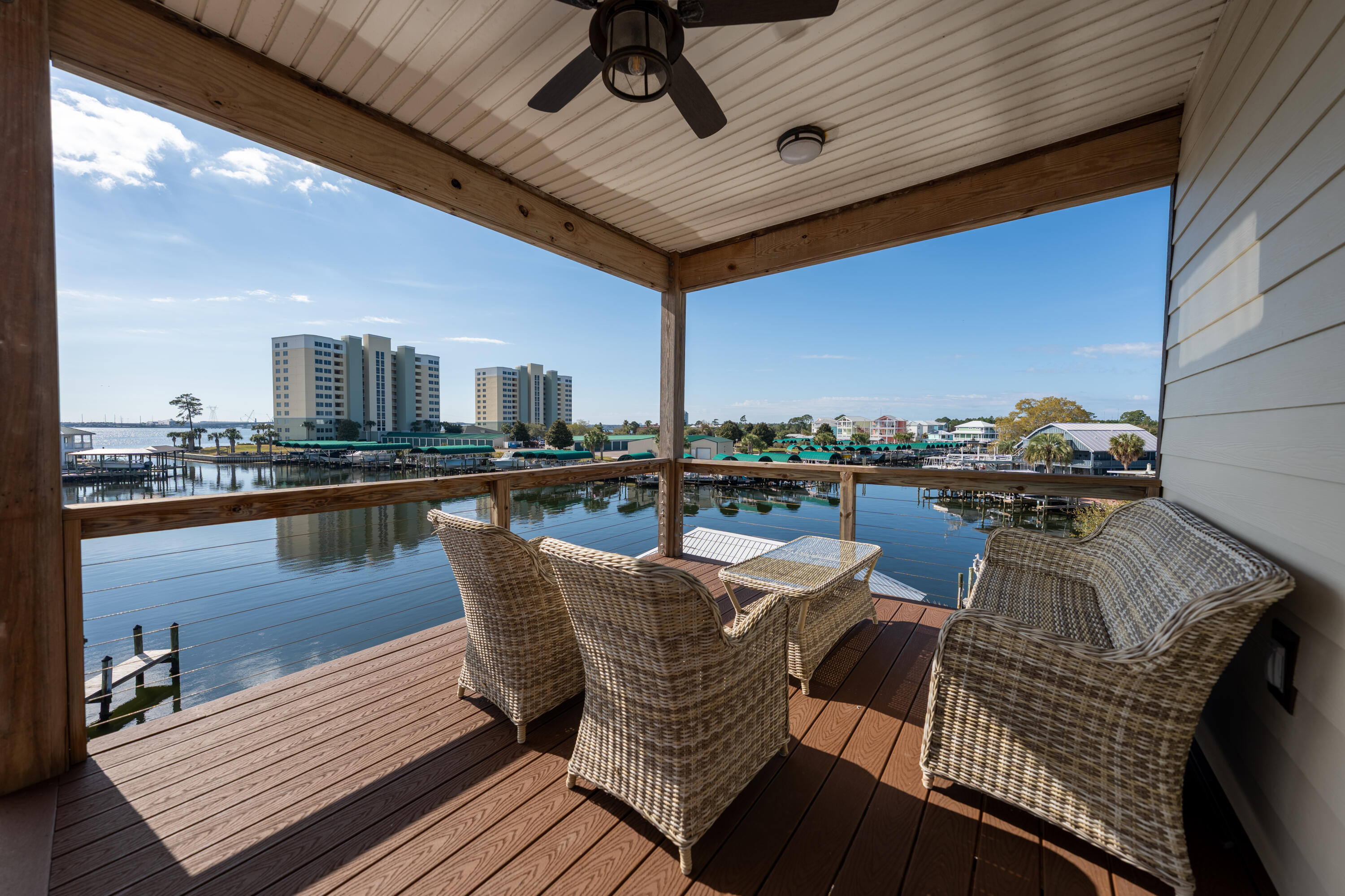 Welcome to 6215 Big Daddy Drive. This beautifully furnished waterfront retreat offers the best of coastal living and modern comfort. A fully decorated 3-bedroom, 3-bath, two-story home features charming coastal decor throughout and incredible views of the water by day and glowing Hathaway Bridge by night. Enjoy direct canal access that leads straight to the Gulf, complete with your own private dock for easy boating and fishing adventures. Relax on one of the two spacious balconies while taking in the serene water views or unwind in the comfy indoor spaces designed for both style and relaxation. The huge garage provides plenty of room for vehicles, storage, or water toys. Whether you're looking for a vacation getaway, an investment property, or your forever home, this move-in-ready waterfront gem has it all.