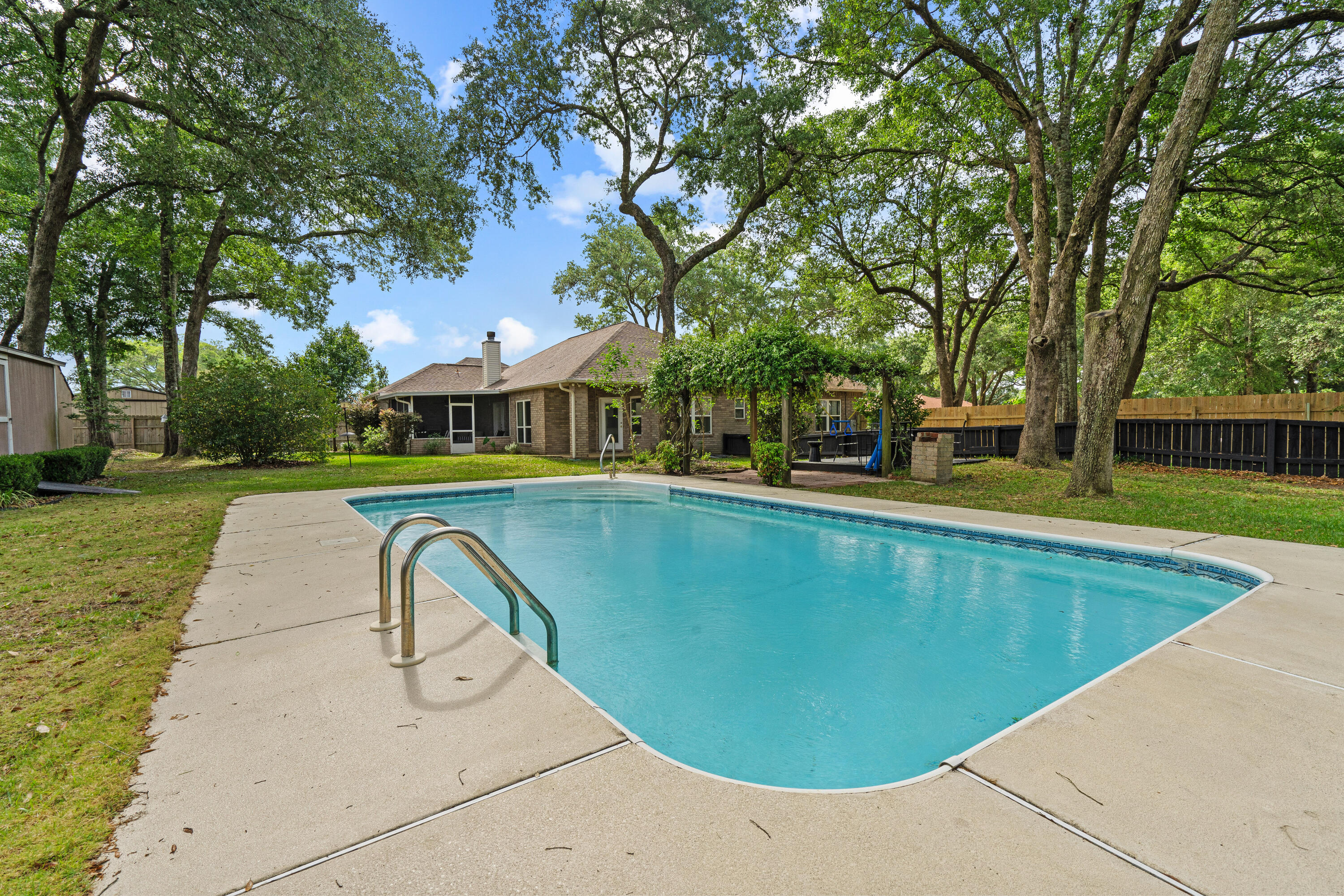 Nestled on a generous double lot, is a stunning blend of contemporary elegance and nature's bounty. This charming 1998 home has been thoughtfully upgraded, offering a fresh, modern interior that complements its inviting character. As you step outside, a lush tapestry of mature tangerine trees, vibrant blueberry bushes, and an array of delectable berries, including huckleberries, raspberries, and blackberries, creates a private oasis. The spice garden, featuring asparagus and other aromatic herbs, invites culinary creativity. A beautiful in-ground pool sparkles under the sun, perfect for relaxation and entertaining. This home embodies a seamless harmony between comfortable living and vibrant outdoor beauty, making it an idyllic retreat for those who cherish nature and modern convenience.