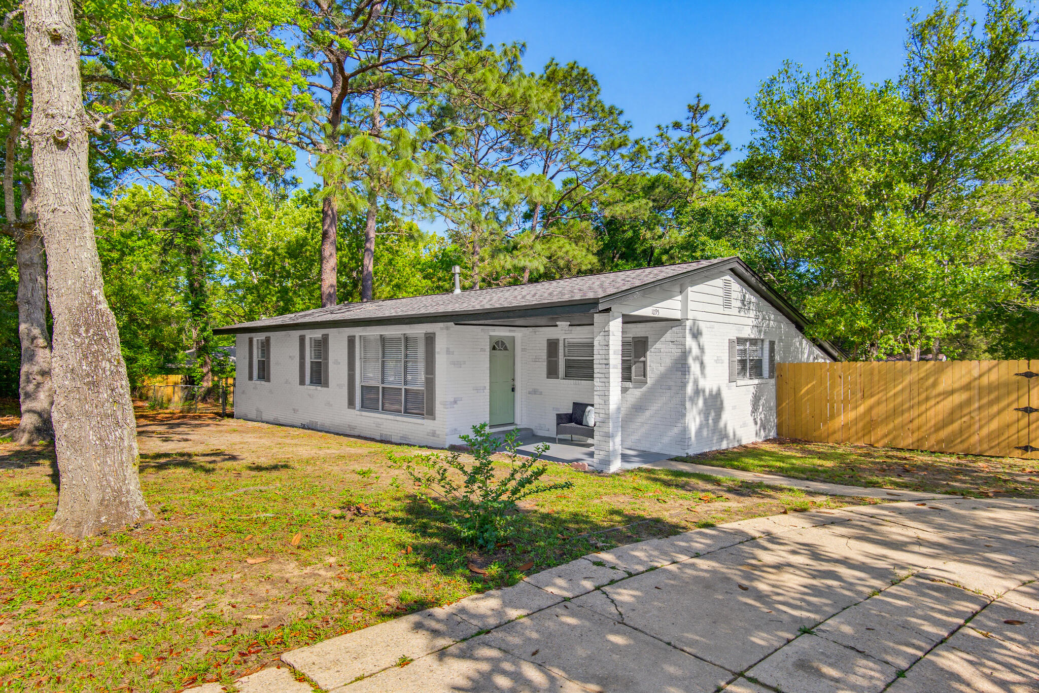 Spacious and beautifully updated 5 bedroom, 2 bathroom brick home situated on a large corner lot in Crestview! This move-in ready property offers hardwood and tile flooring throughout -- no carpet -- along with granite countertops, updated finishes, and an abundance of flexible living space. The bright kitchen features stainless steel appliances, white cabinetry, and plenty of counter space, while the oversized laundry room provides exceptional storage and functionality.

The primary suite includes an additional bonus room perfect for a home office, gym, nursery, oversized closet, or private retreat space. Outside, enjoy a fully fenced backyard with plenty of room to entertain, pets to roam, or future outdoor additions. The circle driveway provides ample parking and easy access for guests.

Conveniently located near schools, shopping, dining, military bases, and all that Crestview has to offer, this home combines space, versatility, and value in one package. Perfect for large households, multi-generational living, or anyone needing extra room to spread out!
