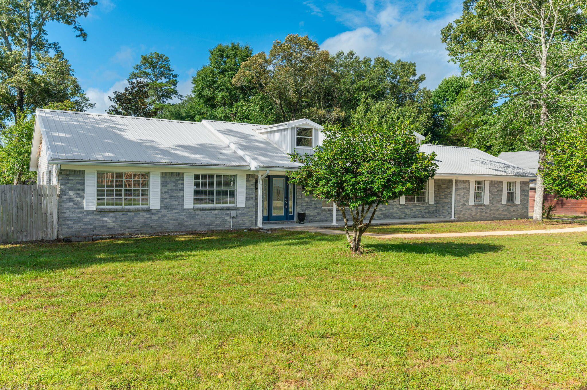 Situated on a beautiful half-acre lot, this spacious 4-bedroom, 3-bath home offers over 2,600 square feet of thoughtfully designed living space with a split floor plan that provides both comfort and privacy.

On the opposite side of the home, three additional bedrooms provide ample space for family and guests, including one bedroom with its own private ensuite bathroom and walk-in shower. A third full bathroom conveniently located in the hallway helps accommodate busy mornings and visiting guests with ease.

Major updates have already been taken care of, including a gas water heater installed in 2024 and a new HVAC system in 2025. The metal roof is believed to have been installed in 2015, providing long-term durability and peace of mind. Even better, the solar panels will be paid in full at closing, allowing the new owner to enjoy the benefits of energy savings without the expense of assuming a solar loan.

Combining generous living space, an ideal layout, and valuable upgrades, this property offers a wonderful opportunity to enjoy comfortable living both inside and out.
