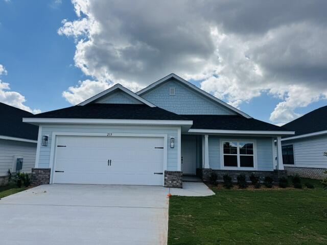 This popular Craftsman-style 3BR/2BA home (currently under construction: (Est. June/July completion) is ideally located close to the entrance of the community (next to model). Designed with both comfort and style in mind, the home features HardieBoard® siding with a brick skirt, 9' ceilings, 8' entry doors, and CoreTec Pro Plus luxury vinyl plank flooring throughout--no carpet. The spacious primary suite boasts elegant tray ceilings, a generous walk-in closet, and a spa-inspired bath. Quartz countertops in the kitchen and baths, soft-close cabinetry, spacious covered patio & wood burning fireplace complete this inviting home, perfect for relaxed everyday living and entertaining. *Pics are of a similar home.* 4.99% fixed interest rate plus Move in Ready package!