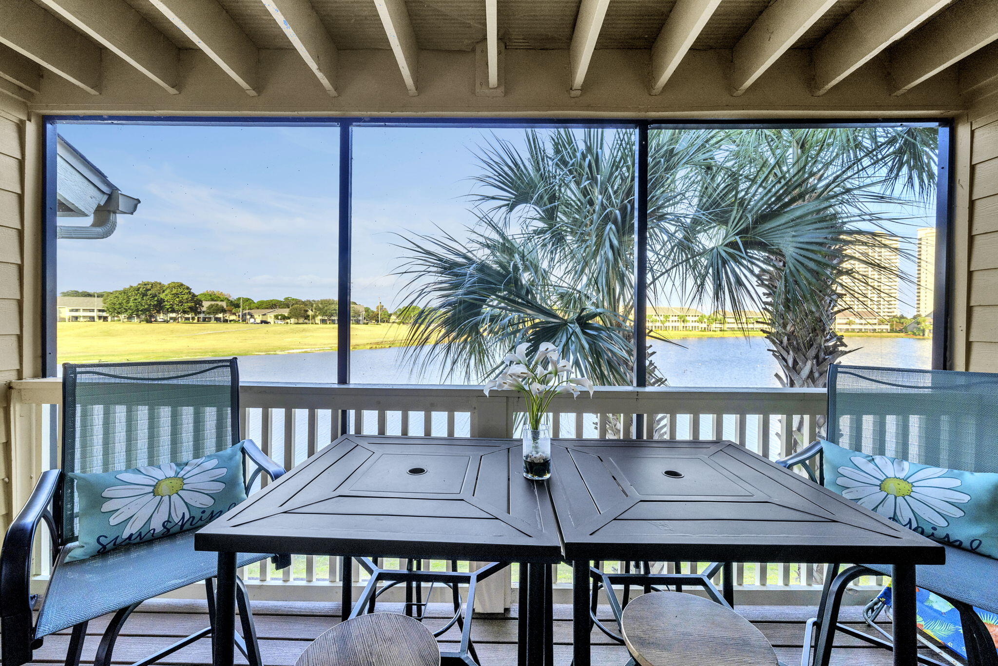 FRACTIONAL OWNERSHIP OPPORTUNITY.  Experience the best of coastal living in this two-level condo perfectly positioned for both beach days and shopping trips. With the shoreline just moments away and sweeping views over Stewart Lake and the golf course, this property delivers a rare blend of vibrant location and serene scenery. Catch a peek of the Gulf from the entry, then enjoy peaceful water views from the main living areas and both screened balconies -- the ideal mix of energy and escape. Inside, the layout is bright and open, designed for comfort. The main floor showcases a spacious living and dining area that flows effortlessly into an open kitchen featuring stainless steel appliances, generous storage, and convenient in-unit laundry. As you progress to the upper level, you are greeted by a roomy private primary suite with an oversized dual vanities, and a luxurious jetted soaking tub. Step out onto the screened balcony and take in the lake views   a perfect morning coffee spot or evening wind-down retreat. On the other side of the primary bathroom you will find a versatile bonus sleeping nook that provides extra guest space and boosts the property's appeal as a vacation or short-term rental opportunity. With screened outdoor spaces on both levels, relaxation is always within reach. Community perks include a resort-style pool, expansive beach access just steps away, and multiple recreation options such as golf, tennis, and basketball. Just minutes away, you'll find popular dining, shopping, and entertainment destinations, putting everything you want right at your fingertips. Whether you're looking for a personal coastal getaway, a full-time residence, or a high-demand rental, this condo checks every box   and then some.