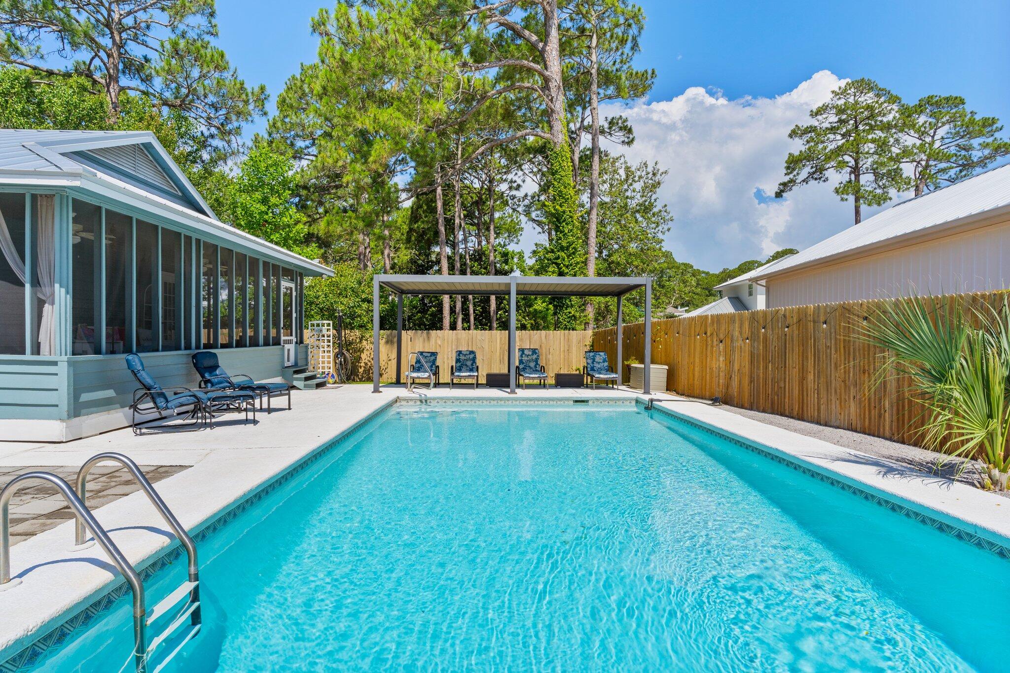 Renovated Beach Cottage w/ private Pool, Bay Access & DREAM Location! This adorable cottage offers the perfect blend of charm, comfort, & convenience—all just a 5-min golf cart ride to the beach and mere steps to the bay, where you can easily launch your boat, kayaks, or paddleboards! Nestled in a quiet, friendly neighborhood with NO HOA, this home boasts an oversized driveway—perfect for guests or storing your boat. The spacious backyard has a gorgeous heated salt water gunite pool, ideal for relaxing after a day in the sun. Unwind in the expansive screened-in porch, perfect for enjoying warm coastal evenings.  Inside, you'll find tasteful updates throughout, preserving the cottage's cozy character while offering modern comforts. New metal roof in 2022!