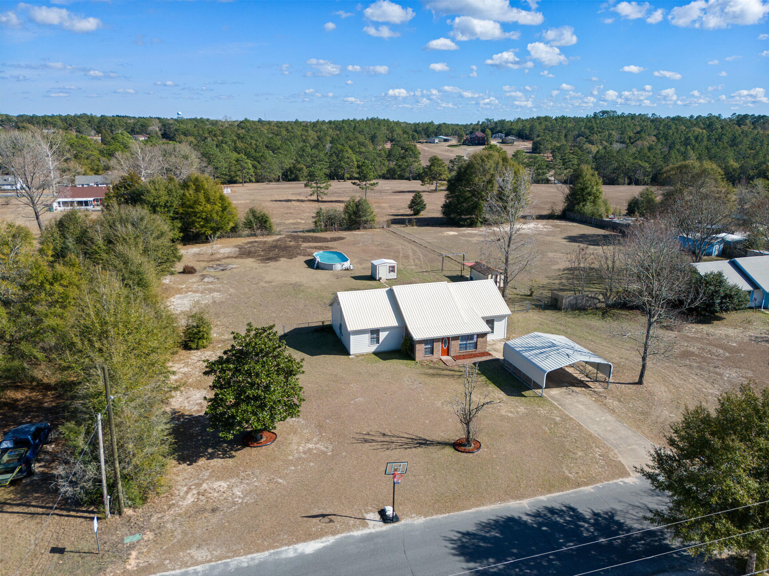 Set on a full acre in Crestview, this 4-bedroom, 2-bath home offers the kind of space and flexibility that's getting harder to find. Inside, the sellers have taken care of the heavy lifting with a freshly painted interior, updated flooring, new kitchen fixtures, and a recently replaced dishwasher. Simple, modern updates that make the home feel refreshed and move-in ready.

Step outside, and this property really earns its keep. The expansive lot provides room to spread out, work, and play, featuring two powered storage sheds, a metal carport, and an above-ground pool ready for Florida summers. With fresh landscaping in the front and backyard, you won't even have to break a sweat to enjoy home! Whether you need space for hobbies, equipment, or just breathing room, this backyard delivers. Major systems have been thoughtfully maintained, including a metal roof replaced in 2019, water heater in 2021, and HVAC from 2012 with UV light treatment. All air ducts and insulation were replaced in 2025, offering peace of mind and improved efficiency.

If you've been searching for a property with land, functionality, and updates already handled, 118 Stephens Lane is one worth seeing in person.