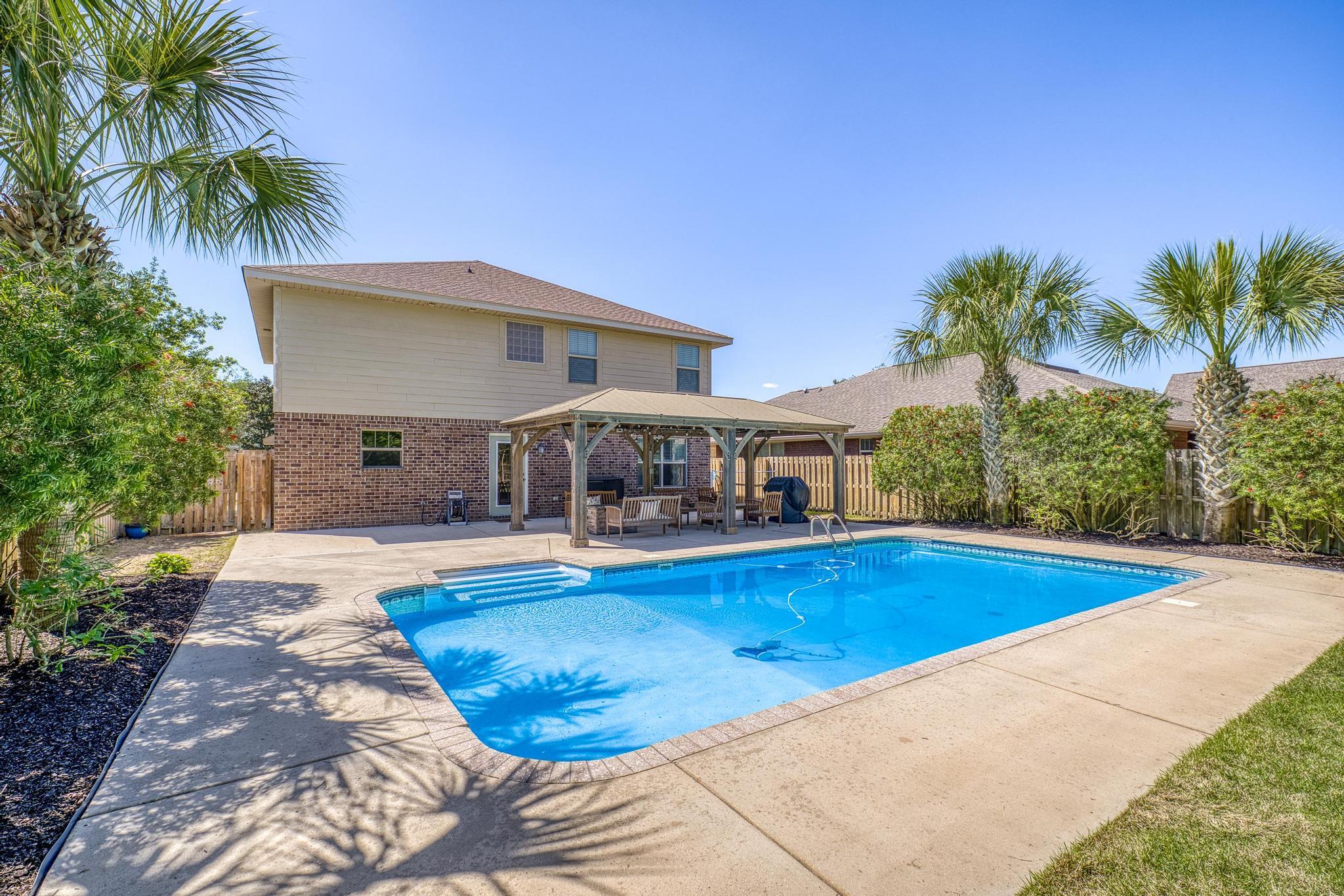 Motivated Sellers!!!Discover this stunning modern coastal contemporary two-story home in the highly sought-after Woodlawn Heights community of Gulf Breeze. Boasting five spacious bedrooms, three full baths, a generous family room, and a versatile bonus loft, this 2015-built residence offers approximately 2,288 square feet of thoughtfully designed living space.
Inside, enjoy updated features and high-end finishes throughout, including a chef-friendly kitchen with granite counters, stainless steel appliances, a breakfast bar, and an open layout perfect for entertaining. The bright, airy interiors create a welcoming atmosphere ideal for both relaxing and hosting.
Step outside to your private backyard oasis -- a true resort-style retreat featuring mature palm trees, lush tropical landscaping,  and a large heated saltwater pool. Gather around the lighted scenic pavilion with its cozy fire pit for unforgettable evenings under the stars. Whether you're swimming year-round or entertaining family and friends, this outdoor space delivers everyday luxury.
Woodlawn Heights offers an exceptional lifestyle with community ponds, a playground, walking trails, and sidewalks throughout. A public boat launch is conveniently located within a half mile, making it easy to enjoy Santa Rosa Sound and the Gulf. The neighborhood is situated just 15 minutes from Navarre Beach, 20 minutes from Pensacola Beach, and less than 30 minutes from both downtown Pensacola and Hurlburt Field. Everyday conveniences are even closer -- Walmart, Publix, and Lowe's are all less than 10 minutes away.
This prime location combines coastal charm, modern comfort, and unbeatable access to beaches, bases, shopping, dining, and top-rated schools. Don't miss your chance to make this move-in-ready home yours!"