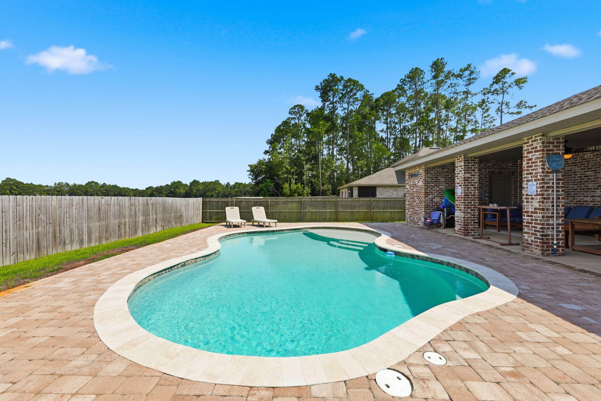 Built in 2023 and offered fully furnished, this move-in ready 5 bedroom, 3 bathroom home offers over 2,600 square feet of thoughtfully designed living space in one of Navarre's quiet neighborhoods.

Inside, you'll find an open-concept layout featuring luxury vinyl plank flooring throughout the main living areas, granite countertops, shaker-style cabinetry, stainless steel appliances, crown molding, tray ceilings, and abundant natural light. Every room has been carefully furnished and designed, allowing the next owner to move in and immediately start enjoying everything this home has to offer.

The backyard is where this property truly shines. A stunning custom pool creates your own private retreat, while the covered patio and fully fenced yard provide the perfect space for entertaining, relaxing, or spending time with family and friends.

Whether you're searching for your forever home, a vacation home on the Emerald Coast, or an income-producing investment property, this home offers the flexibility to fit your lifestyle. Built in 2023, sold fully furnished, and loaded with upgrades, this is a rare opportunity to own a home that's truly ready from day one.