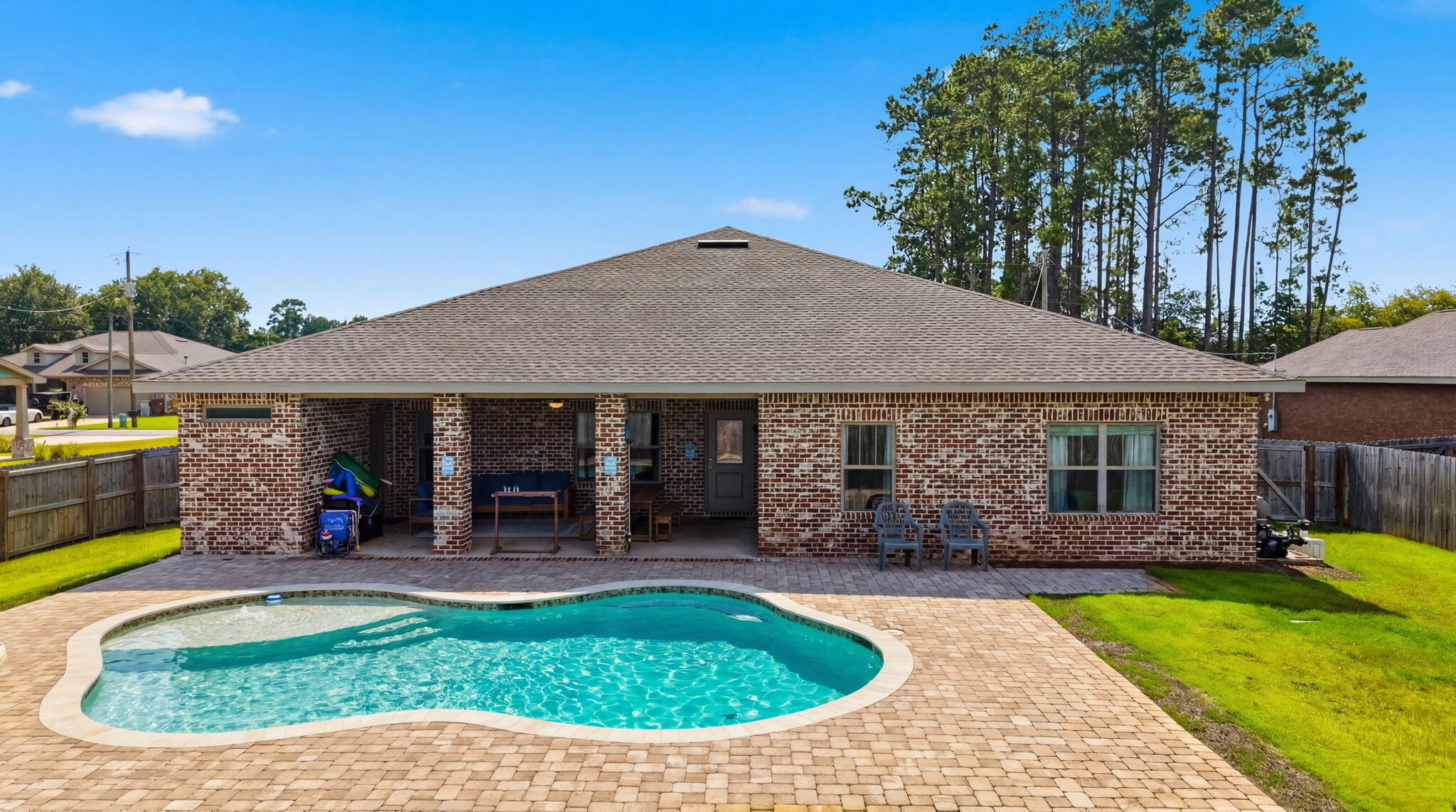 Built in 2023 and offered fully furnished, this move-in ready 5 bedroom, 3 bathroom home offers over 2,600 square feet of thoughtfully designed living space in one of Navarre's quiet neighborhoods.

Inside, you'll find an open-concept layout featuring luxury vinyl plank flooring throughout the main living areas, granite countertops, shaker-style cabinetry, stainless steel appliances, crown molding, tray ceilings, and abundant natural light. Every room has been carefully furnished and designed, allowing the next owner to move in and immediately start enjoying everything this home has to offer.

The backyard is where this property truly shines. A stunning custom pool creates your own private retreat, while the covered patio and fully fenced yard provide the perfect space for entertaining, relaxing, or spending time with family and friends.

Whether you're searching for your forever home, a vacation home on the Emerald Coast, or an income-producing investment property, this home offers the flexibility to fit your lifestyle. Built in 2023, sold fully furnished, and loaded with upgrades, this is a rare opportunity to own a home that's truly ready from day one.