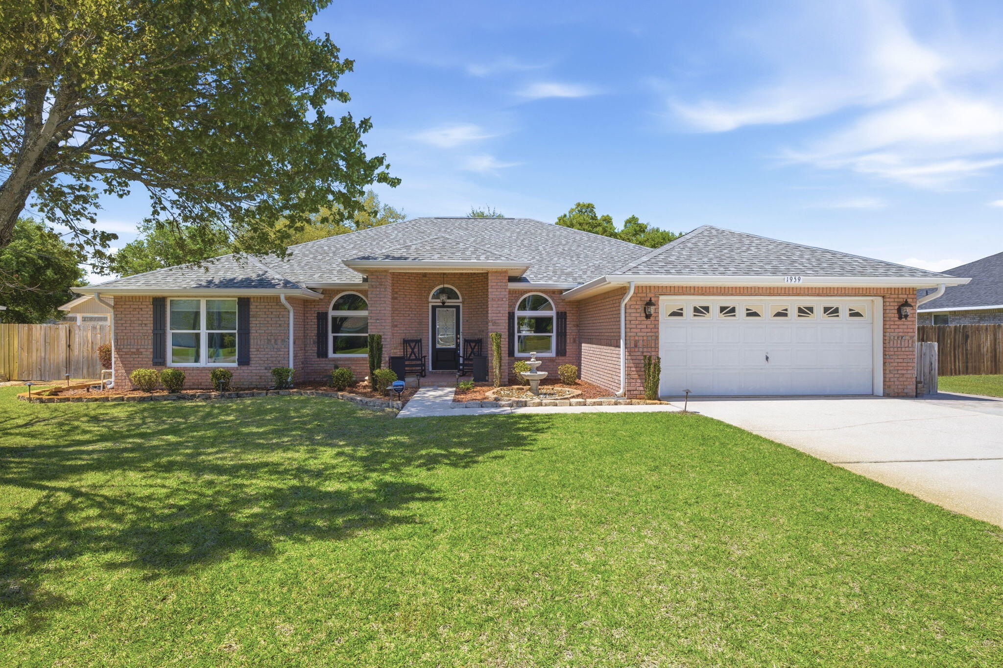 Welcome to this spacious and beautifully maintained and updated brick home nestled on almost half an acre in one of Navarre's most sought-after neighborhoods. Offering over 2,700 SqFt of living space - with 4 bedrooms, 3 full bathrooms, a gorgeous designated office with arched glass french doors, an expansive open concept main living space, an eat-in kitchen/breakfast nook, formal dining space, indoor laundry room, and more! Durable and beautiful wood-look tile flooring flows throughout the bedrooms and main living spaces, providing a modern aesthetic and easy maintenance. The kitchen features charming maple wood cabinets, an island with a new induction cooktop with downdraft vent, a KitchenAid wall oven and microwave combo, and granite countertops. The massive great room is accented by a a cozy, corner, wood-burning fireplace. Enjoy a split floor plan for added privacy. The primary suite boasts a tray ceiling and an oversized ensuite bathroom with walk-in shower, step-in tub, double vanity, and a walk-in closet. The remaining 3 bedrooms and 2 full bathrooms are on the opposite side of the home. Step outside the slider doors to the backyard Oasis - starting with a covered patio perfect for alfresco dining or relaxing in the shade taking in the views of the sparkling in-ground heated salt water pool - powered by natural gas. The backyard also includes a dedicated workshop and a storage shed. Enjoy peace of mind with all newer major systems - including a 2022 Roof, 2022 tankless gas water heater, a 2024 HVAC and Air Scrubber, and all new hurricane impact rated doors and windows throughout! Ownership also grants you access to all the amenities Holley By The Sea has to offer - including a boat ramp, 8 clay tennis courts, a community event hall, 3 different pools, exercise room, and more! Schedule your showing today!