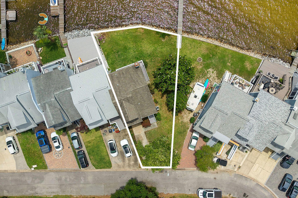 VIEWS! VIEWS! VIEWS! No HOA and your own waterfront paradise awaits! Enjoy breathtaking panoramic views of the bay and bayou from this beautifully updated end-unit home. A true sailor's dream and a wonderful place to raise a family, with Lincoln Park and a fishing pier just a short walk away. This waterfront retreat offers spectacular water views from nearly every room and includes access to a shared dock, making it easy to enjoy boating, fishing, kayaking, paddleboarding, or simply soaking in the waterfront lifestyle.Recent updates include luxury vinyl plank flooring, granite countertops, backsplash, updated lighting, ceiling fans, painted cabinetry with new hardware, and updated outlets and switches throughout. Major improvements include HVAC (2025), Roof (2016), and Water Heater (2014). Wake up each morning in the primary suite to romantic water views and starlit evenings reflected across the bay. The primary bath features a new vanity and walk-in closet. The kitchen, living room, dining area, and second bedroom all showcase the same incredible waterfront scenery. Imagine starting your day with a cup of coffee while watching dolphins play and feed just outside your window. Whether you're boating, fishing, entertaining, or simply relaxing, this home delivers a waterfront lifestyle that feels like a vacation every day. Stop the world for a moment and enjoy the view--this is coastal living at its finest!