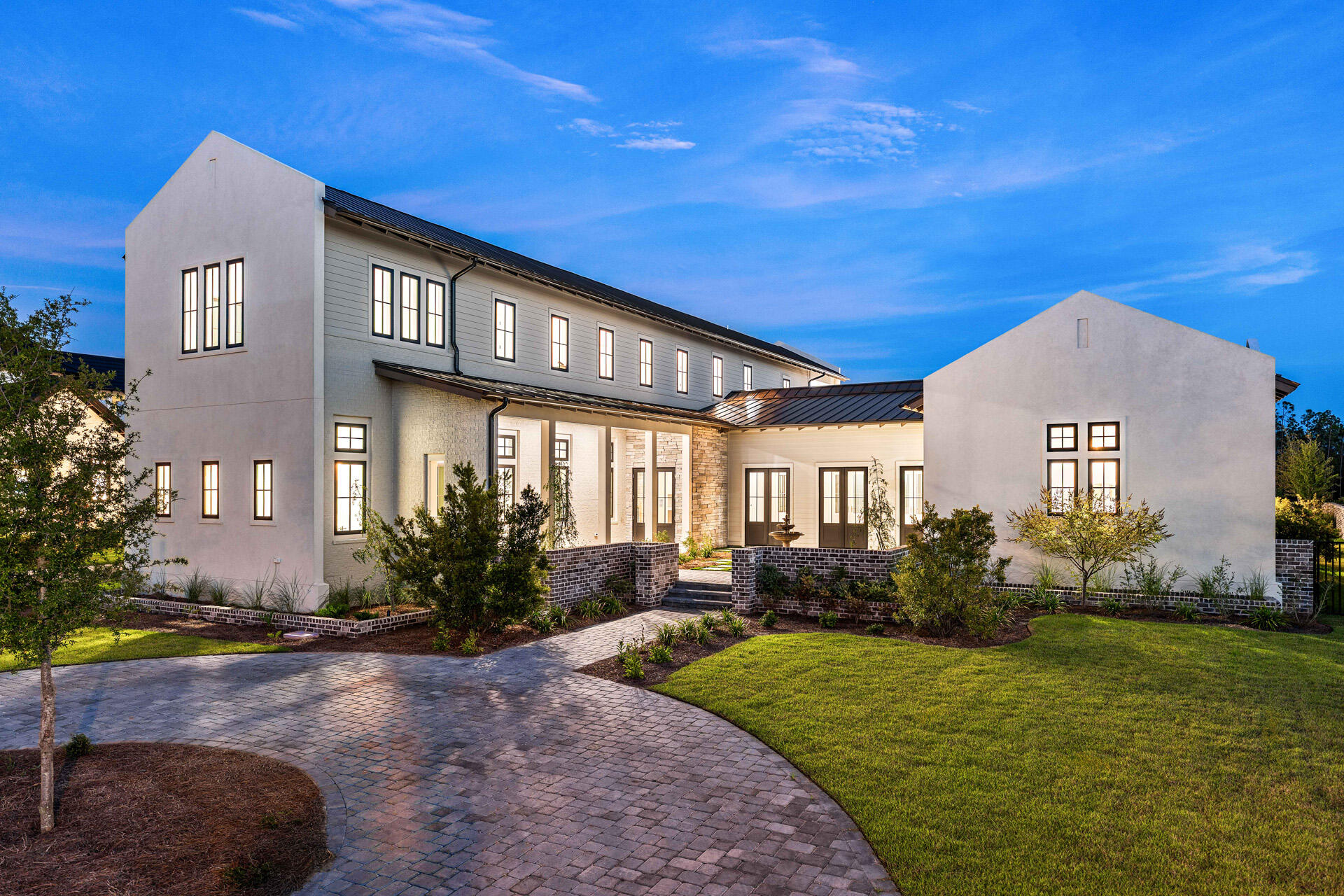 A showstopper of modern coastal elegance, 36 Sandcord Drive is a brand-new luxury estate within the gated enclave of Watersound Camp Creek. Spanning 6,065 square feet with five bedrooms and six-and-a-half bathrooms, this two-story residence was designed to live like a private resort. The exterior showcases a refined blend of white stucco, brick, and cedar lap siding, while a brick courtyard wall and mahogany entry doors create an impressive sense of privacy and arrival. Inside, a private elevator, dedicated office, and dramatic living room with vaulted ceilings and architectural columns open to an exceptional backyard sanctuary. The resort-style pool features a wall fountain, sun shelf, and swim-up serving area connecting directly to the outdoor kitchen and bar. The outdoor kitchen materials and appliances have been delivered, and installation is underway. A dedicated gas connection is also in place for the future addition of a fire-lounge feature, allowing the next owner to further customize the pool deck for evenings of outdoor relaxation and entertaining. The oversized corner lot is framed by a wraparound driveway, lush landscaping, and two elegant courtyards, including an entry courtyard with a tranquil fountain. The home offers three generously appointed primary suites--two conveniently located on the first floor and a third upstairs.

The main first-floor primary suite encompasses the home's entire west wing, creating a private retreat with vaulted ceilings, a stone fireplace, direct access to the pool deck, two spacious walk-in closets, a separate dressing room, and an additional washer and dryer hookup. Its spa-inspired bathroom features a freestanding soaking tub, an expansive open walk-in shower, and a distinctive freestanding double vanity positioned away from the wall, allowing access from both sides while facing a full mirrored wall.

A second primary suite is located on the opposite side of the first floor and offers its own private courtyard access. Its beautifully appointed ensuite bathroom includes dual vanities, a freestanding soaking tub, and a spacious walk-in shower, providing guests or multigenerational family members with the comfort and privacy of a true primary retreat.

Upstairs, three additional bedrooms each feature private ensuite bathrooms. Two include vaulted ceilings, while the pool-facing bedroom serves as the home's third primary suite. This spacious upper-level retreat features vaulted ceilings and a private balcony with water views overlooking the pool deck and backyard. Its impressive bathroom is complete with dual vanities, a freestanding soaking tub, and a full walk-in shower.

Thoughtful architectural details, premium finishes, and generously proportioned spaces throughout create a seamless balance of luxury, comfort, and everyday livability. From the three private primary suites and elegant courtyards to the resort-inspired outdoor setting, every element has been designed for elevated coastal living.

Located behind the exclusive gates of Watersound Camp Creek, ownership offers more than an extraordinary home--it provides access to one of Northwest Florida's most sought-after lifestyles. Property ownership includes eligibility for the Watersound Club, with membership options offering access to an array of amenities that may include private beach experiences, championship golf, pools and a lazy river, wellness facilities, tennis, pickleball, and signature dining venues.

36 Sandcord Drive is more than a residence--it is a statement of refined living and timeless comfort along Florida's Emerald Coast. Experience privacy, luxury, and an entertainer's dream within the exceptional Watersound Camp Creek community.